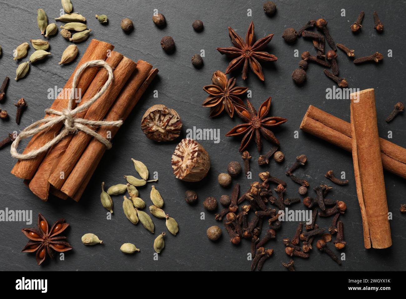 Different spices on dark gray textured table, flat lay Stock Photo