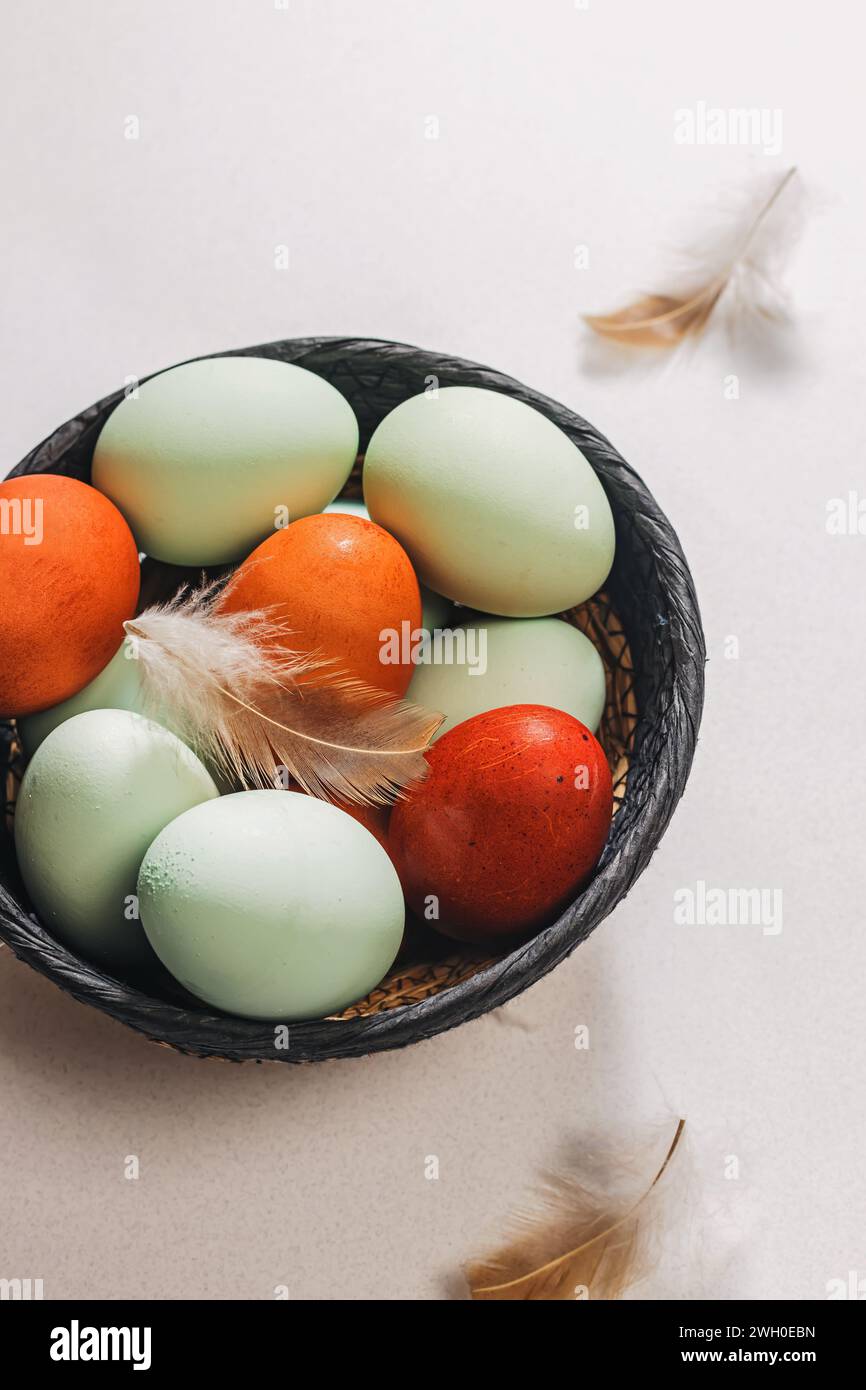 Naturally pastel colored Easter eggs in a basket close-up Stock Photo