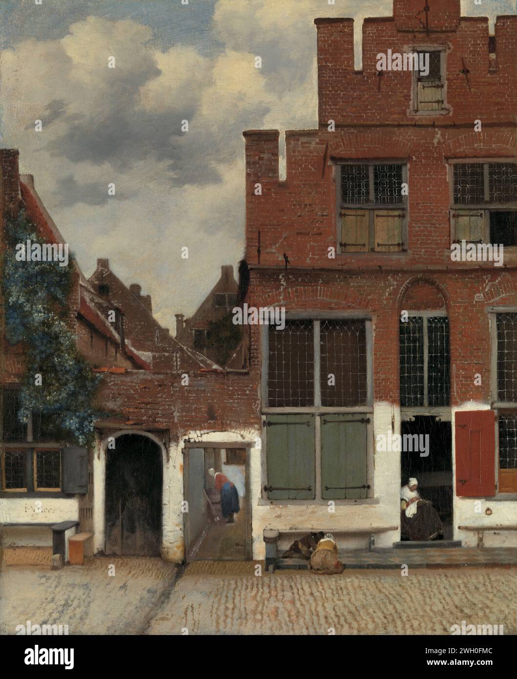 View of Houses in Delft, Known as ‘The Little Street’, Johannes Vermeer, c. 1658 painting View of Huizen in Delft, known as 'the street'. The facades of a few houses on a street in Delft. Between the houses an alley where a woman is bent over a wash. In the open door of the house on the right, a woman is crafted, left in front of the house on the sidewalk two children playing.  canvas. oil paint (paint)  street. civic architecture; edifices; dwellings. children's games and plays (+ out of doors (sports, games, etc.)). home sewing; repair of clothes Delft Stock Photo