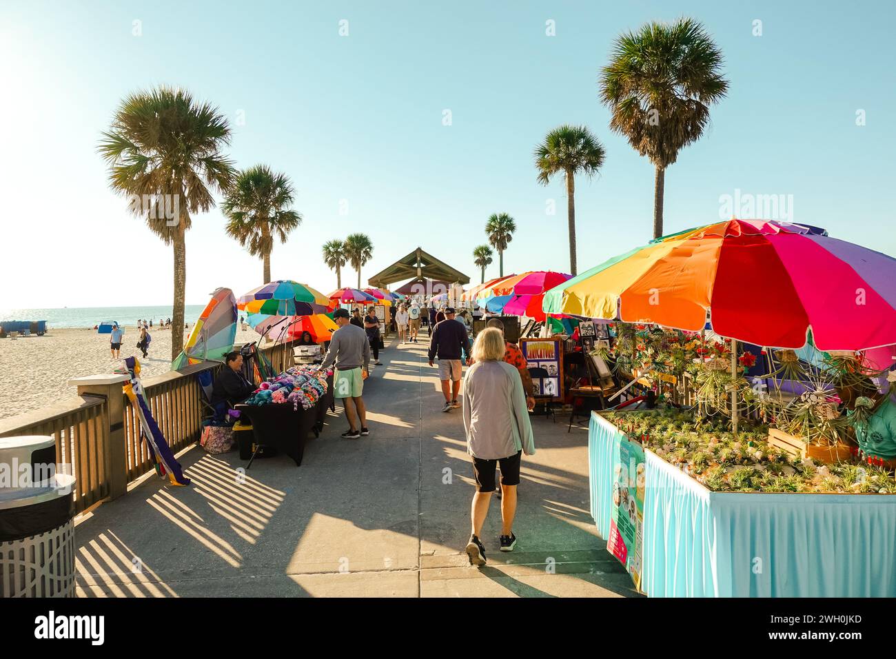 Vibrant outdoor market near a beach in Florida, with stalls, vendors, on a sunny day under clear skies Stock Photo