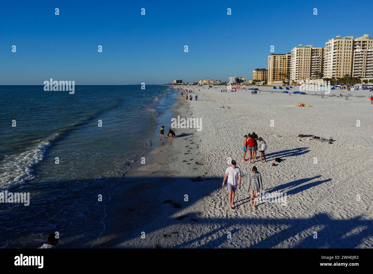 People strolling along the coastline at Clearwater Beach, Florida Stock Photo