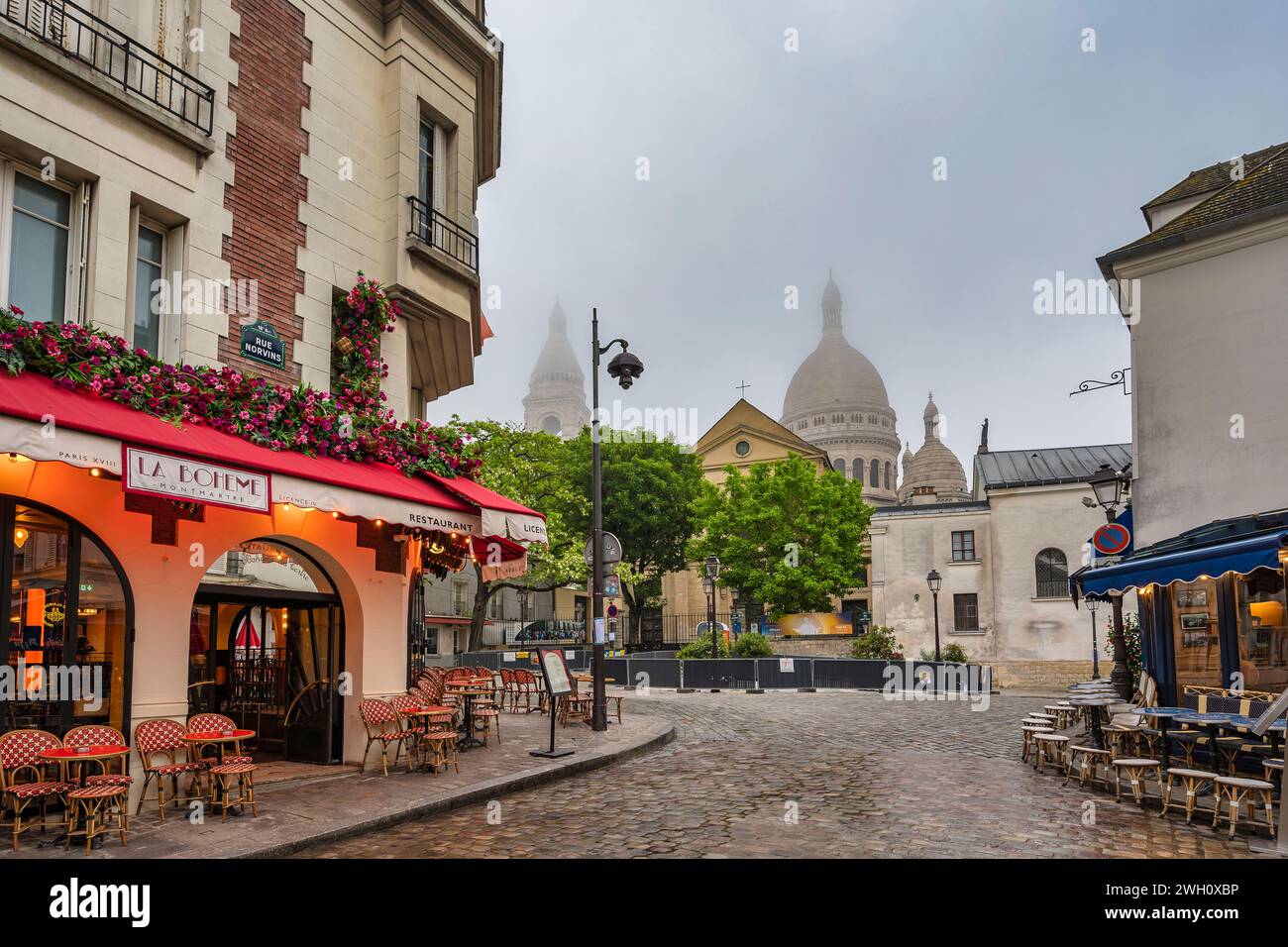 Paris, France - May 14, 2023 : city skyline time lapse of architecture building on Montmartre street and Sacre Coeur Stock Photo