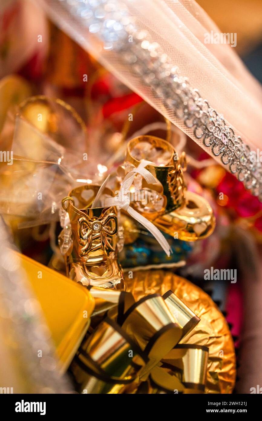 This image showcases a pair of adorable gold baby shoes with a white ...