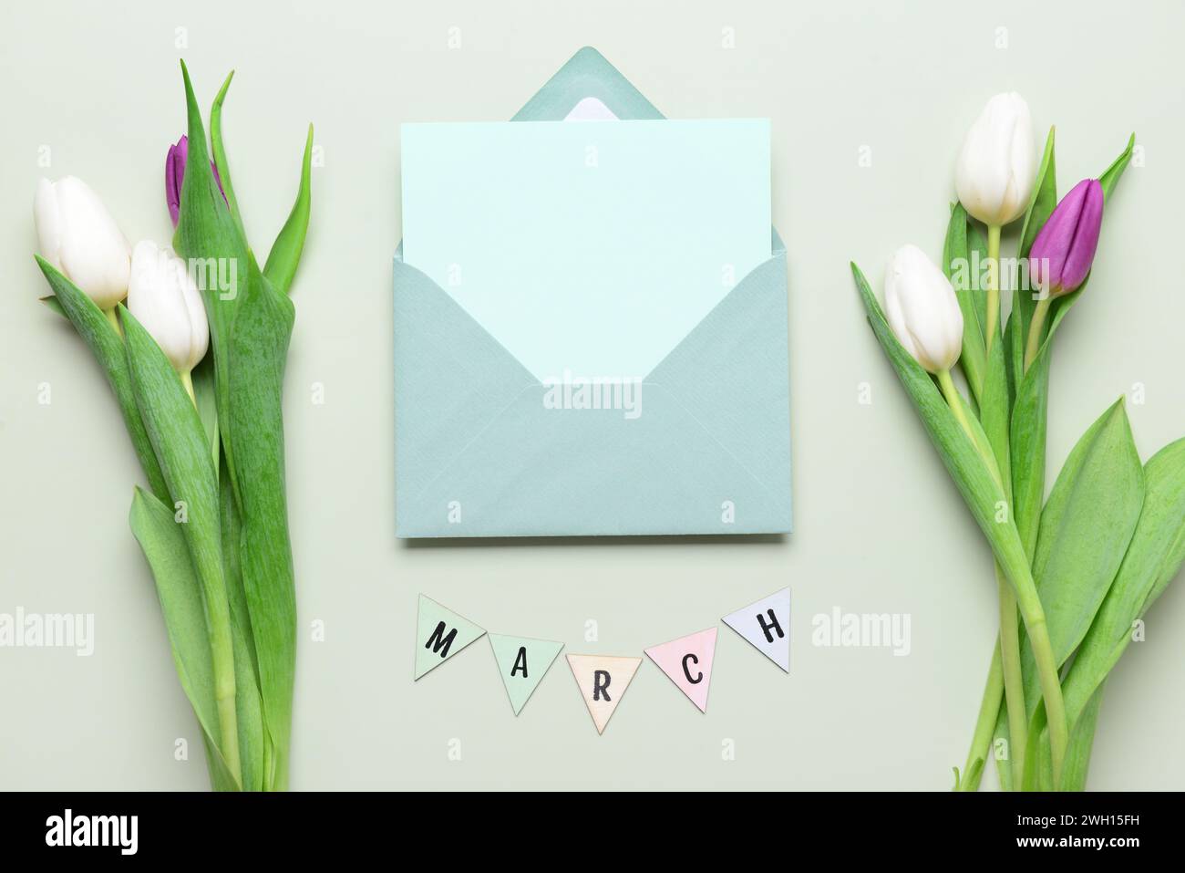 Envelope with blank card and tulip flowers on grey background ...