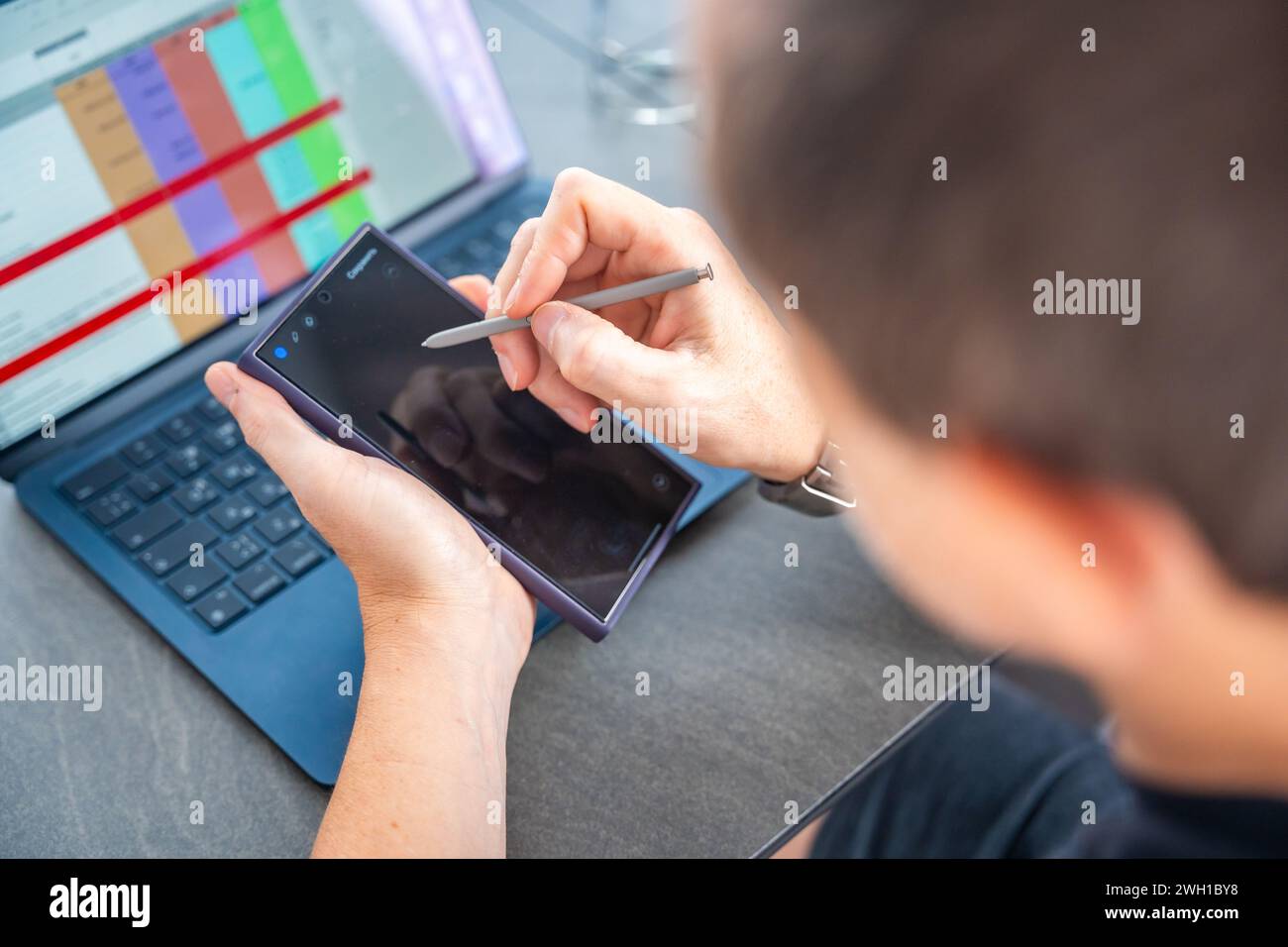 Prague, Czech republic - February 5, 2024: Man works with new Samsung Galaxy S24 Ultra and stylus pen at his creative workspace Stock Photo