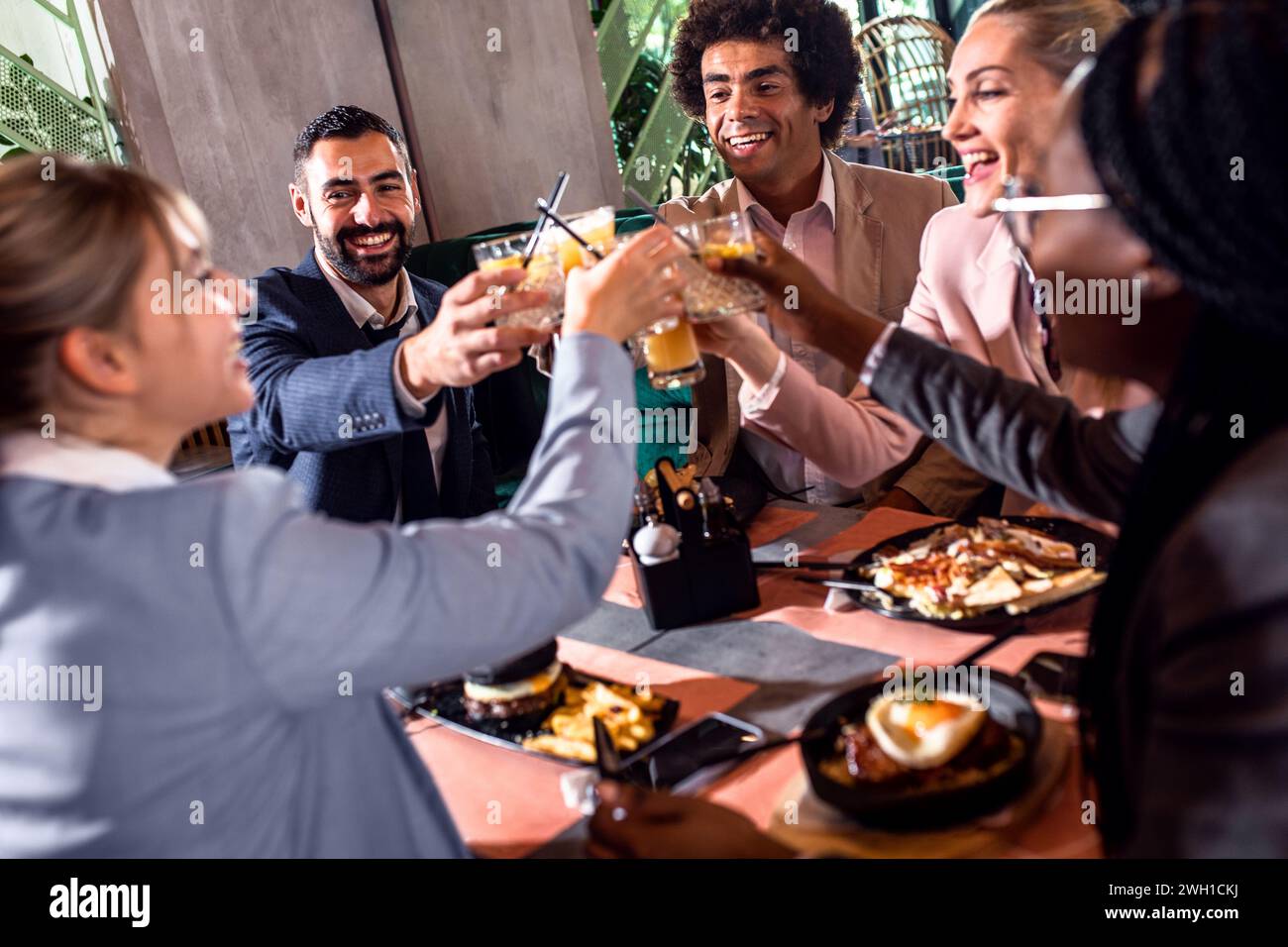 Group of business people in restaurant at lunch. Stock Photo