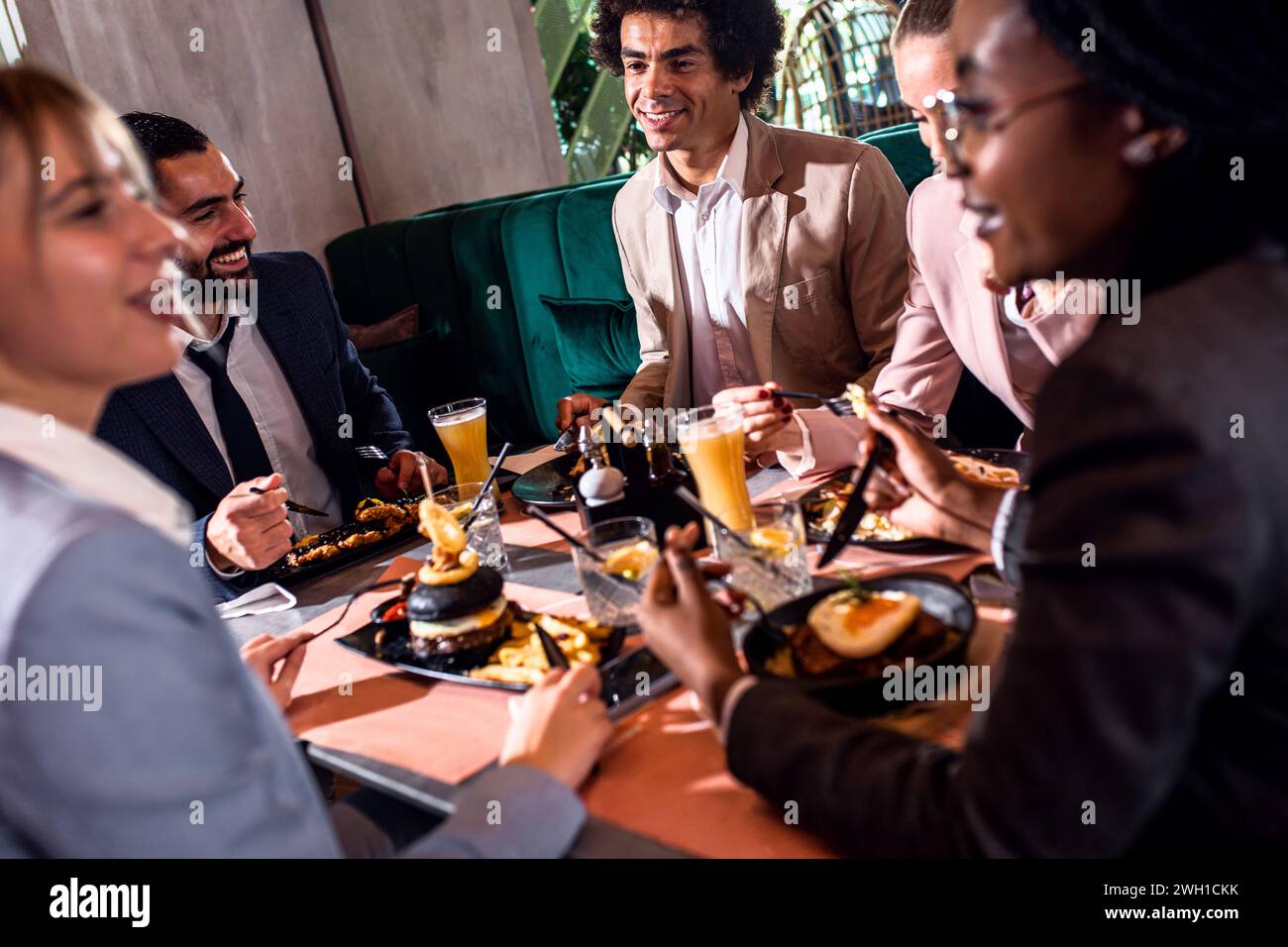 Group of business people in restaurant at lunch. Stock Photo