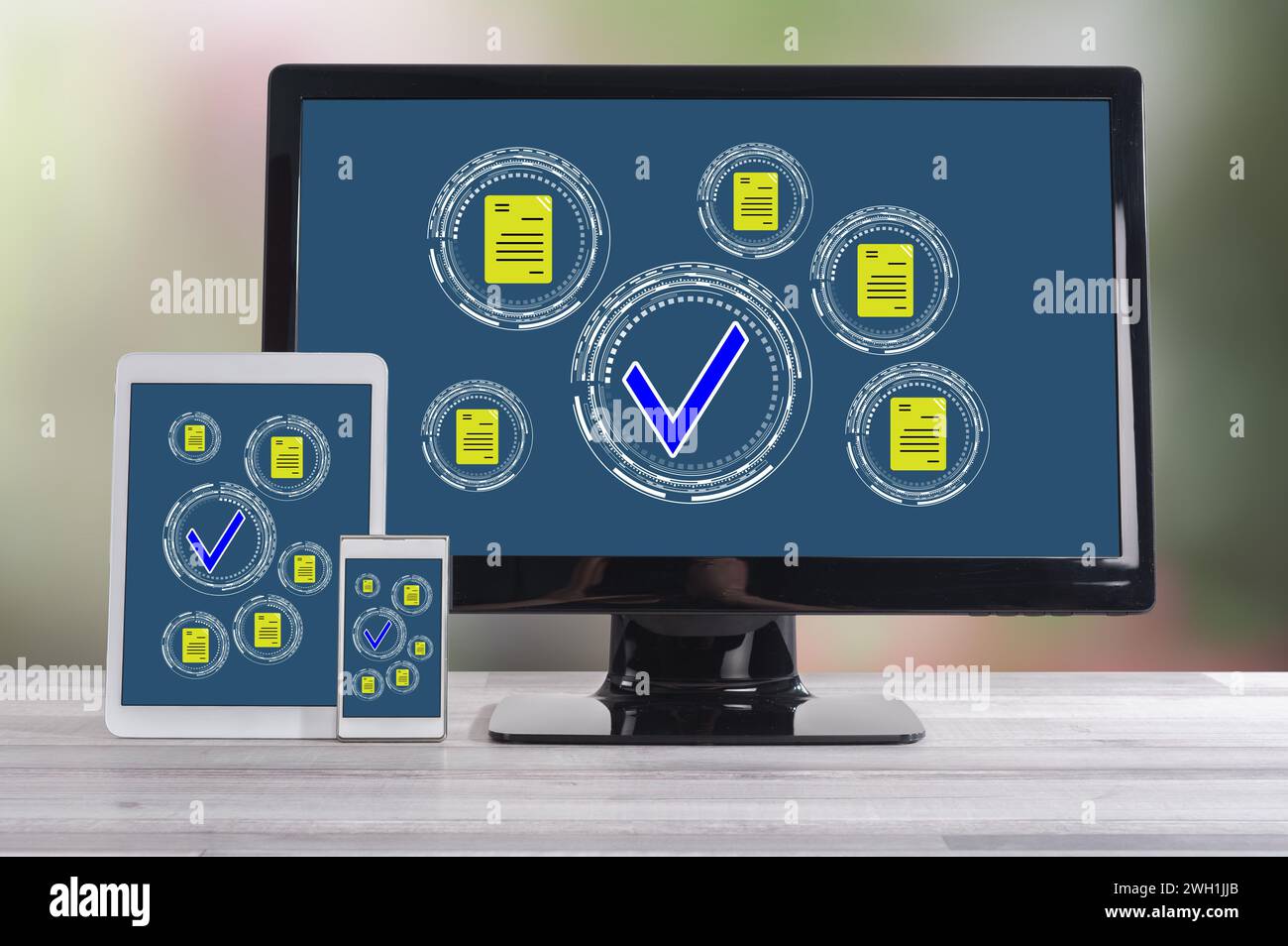 Document validation concept shown on different information technology devices Stock Photo