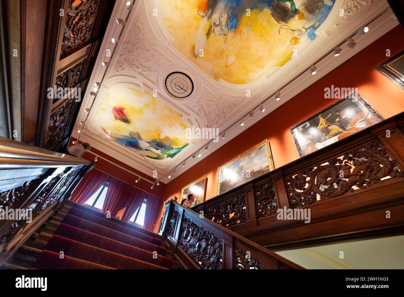 Impressive wooden decorated stairwell with beautifully painted ceiling in museum 'Mauritshuis' in the Dutch city of The Hague Stock Photo
