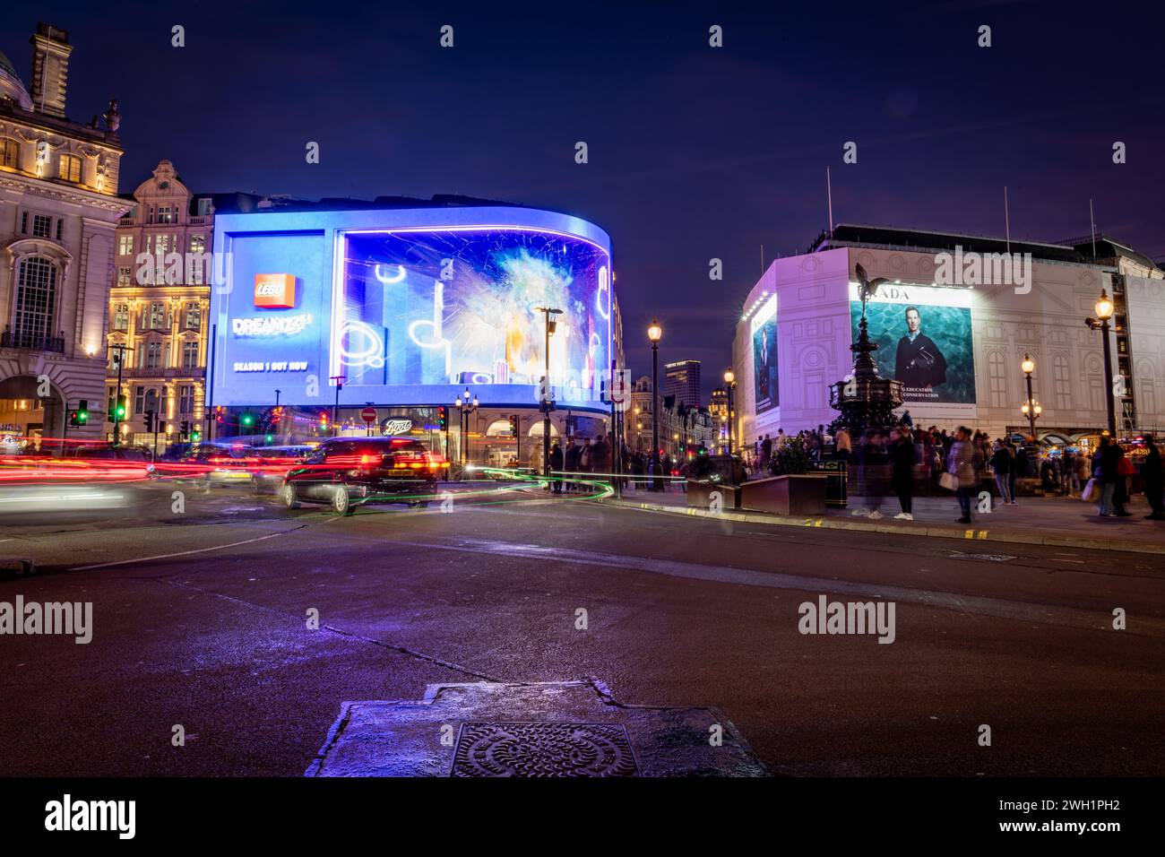 London. UK- 02.04.2024. A night time long exposure view of Piccadilly Circus with travel light trails and the Piccadilly Light. Stock Photo