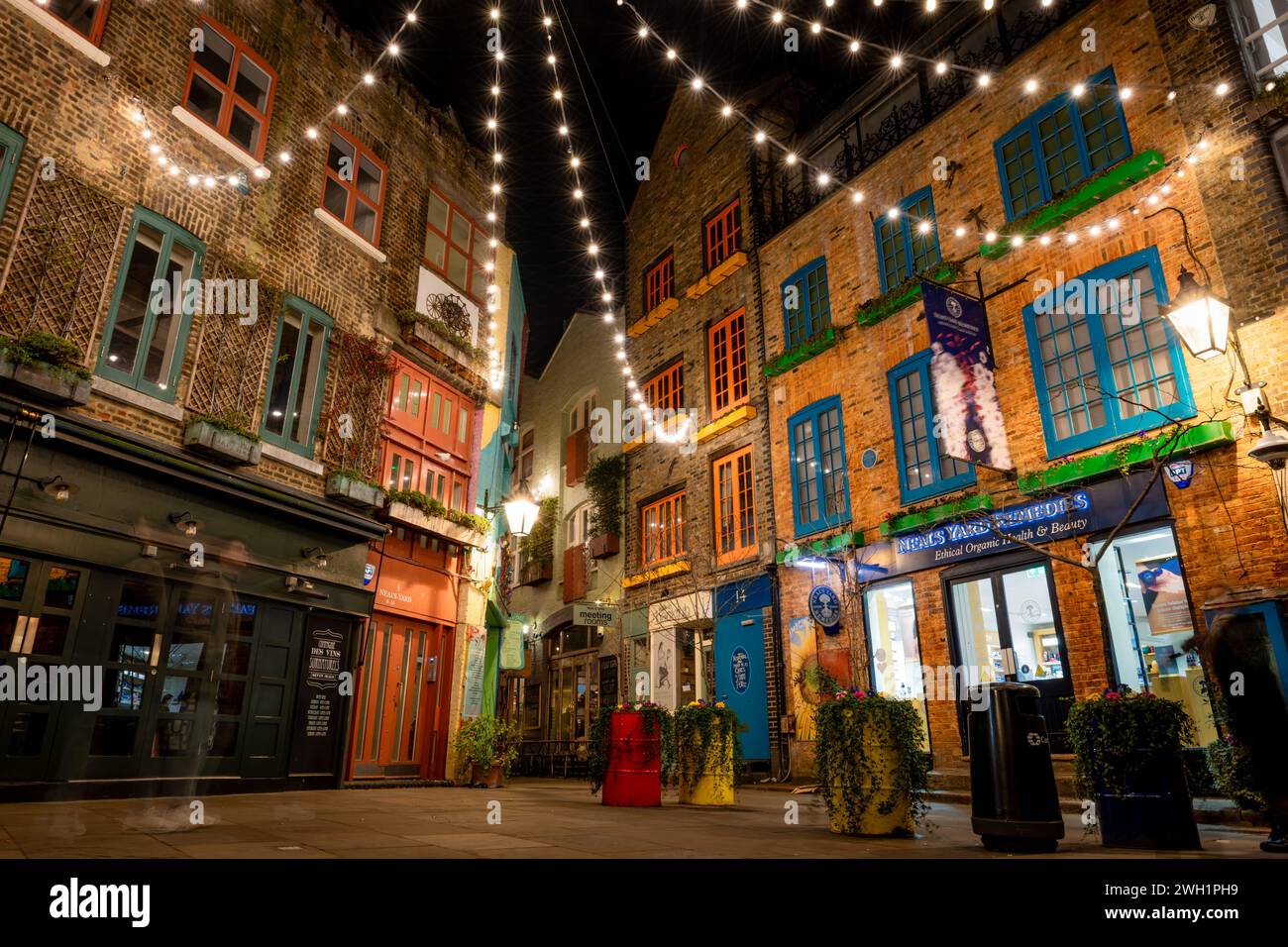 London. UK- 02.04.2024. A night time view of Neal's Yard showing its colourful Victorian warehouse buildings. Stock Photo