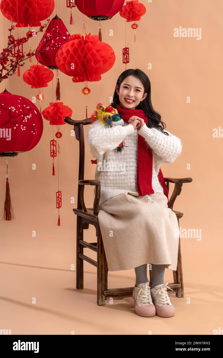 New Year atmosphere, a young Asian woman clasps her fists and wishes Stock Photo
