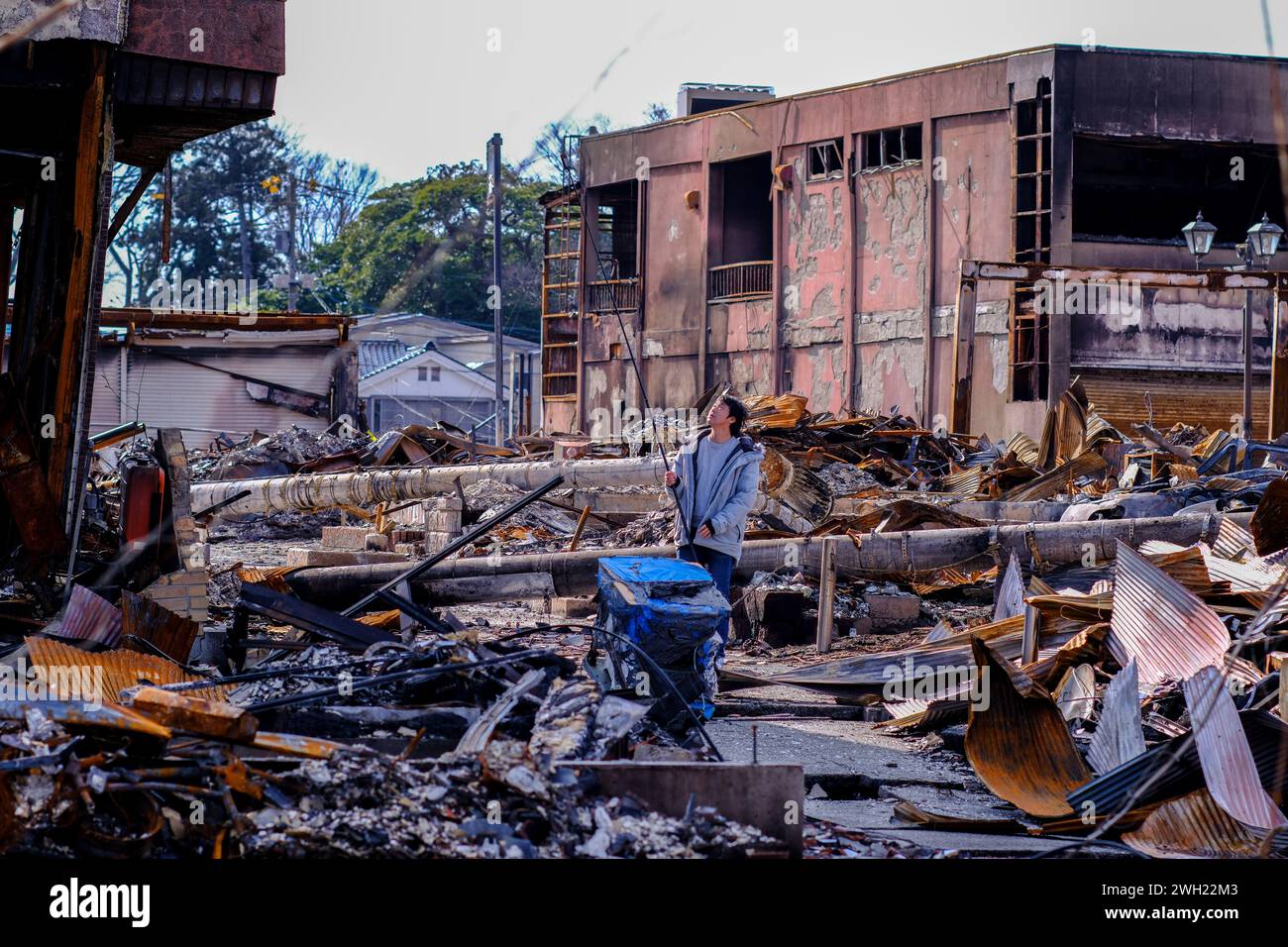 Ishikawa, Japan. 07th Feb, 2024. Koji Furuta, 25, lost his parents and three siblings. He was buried in the rubble and burned to death. He wanders around the Wajima morning market in search of memories of his family. The Noto Peninsula earthquake destroyed the tourist area of Wajima City. (Photo by James Matsumoto/SOPA Images/Sipa USA) Credit: Sipa USA/Alamy Live News Stock Photo