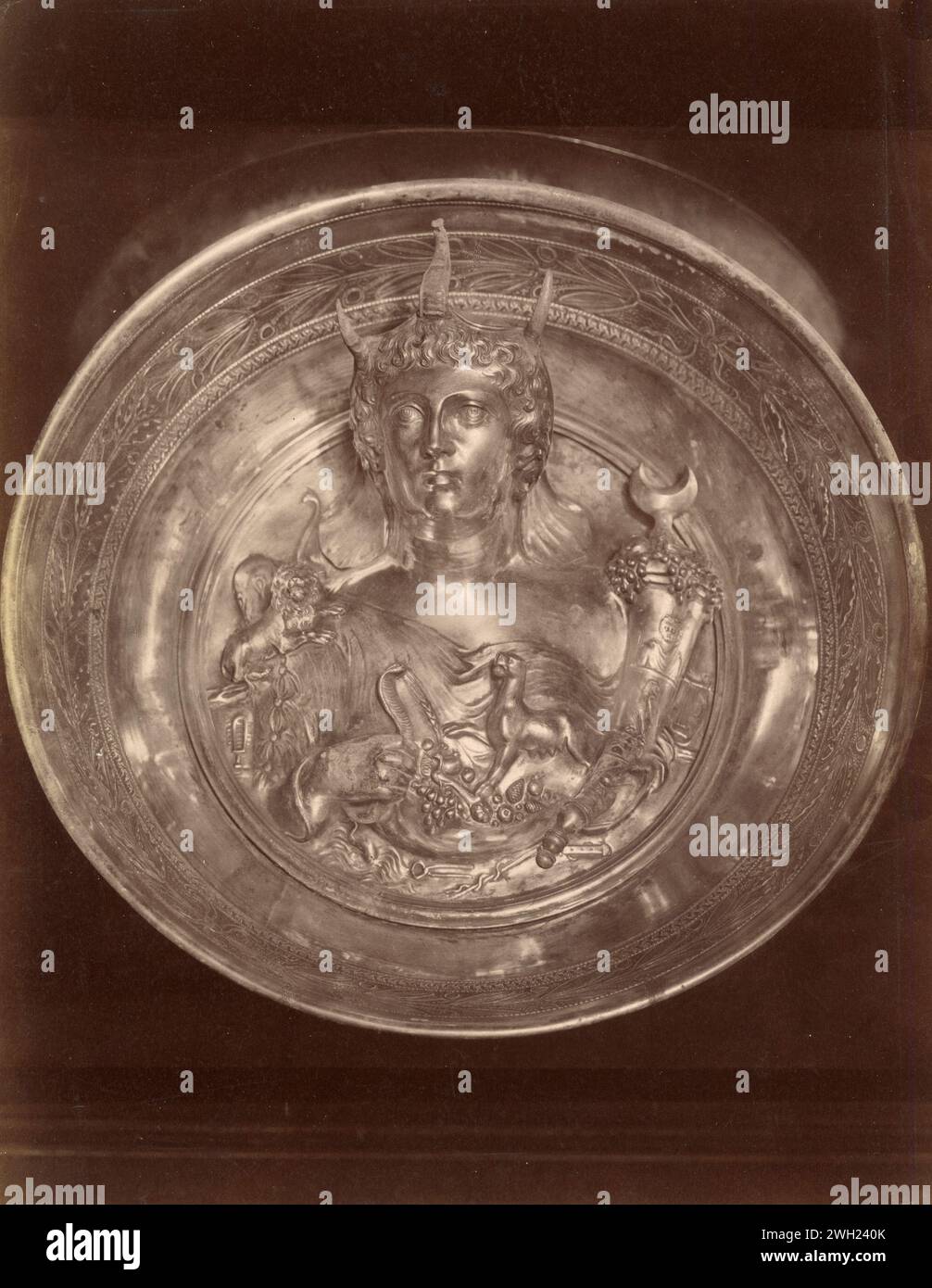 Boscoreale treasure, Gold and silver bowl: Patera with relief depicting bust of woman wearing elephants trunk headdress and holding cornucopia or horn of plenty, France 1900s Stock Photo