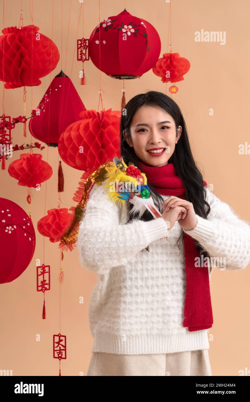 New Year atmosphere, a young Asian woman clasps her fists and wishes Stock Photo