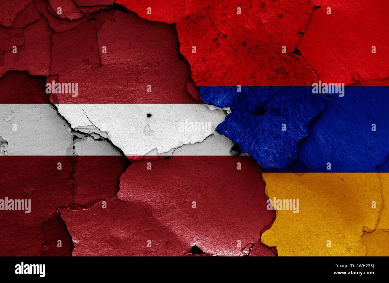 flags of Latvia and Armenia painted on cracked wall Stock Photo