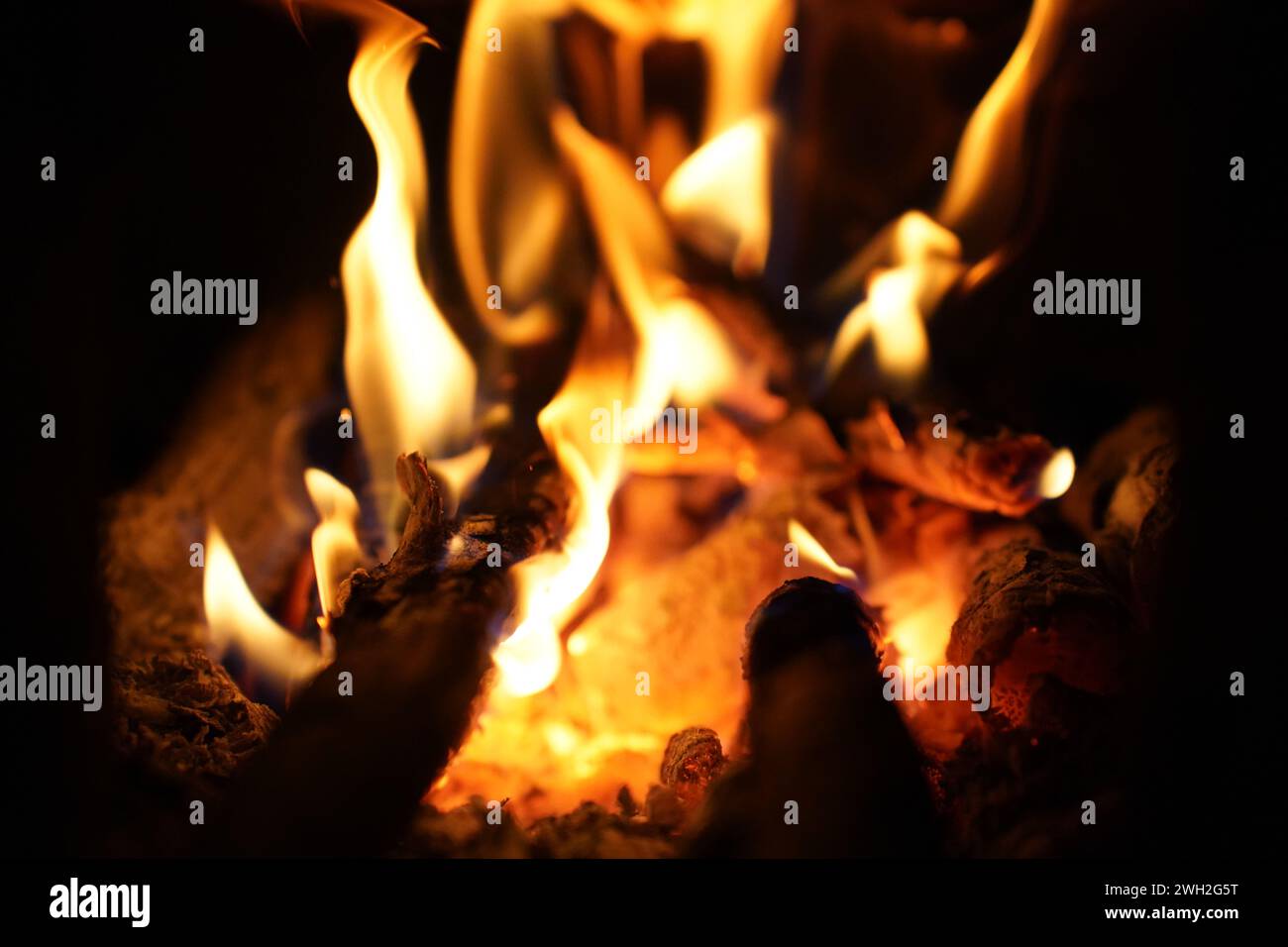 Yellow bright bonfire on black background, horizontal view. Orange ...