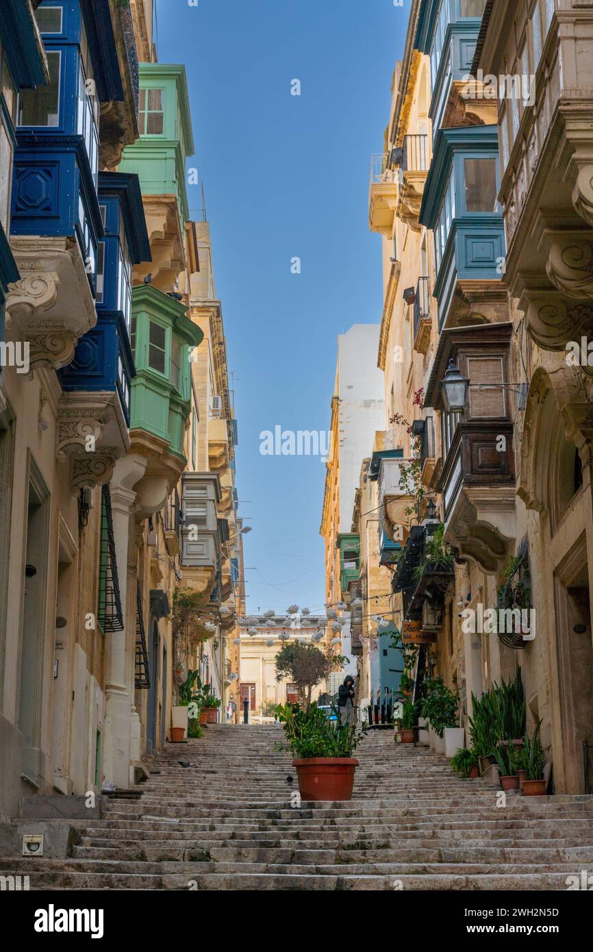 Valletta, Malta - 23 December, 2023: stairs leading up into the old town center of Valletta with a view of many colourful Gallarija balconies Stock Photo