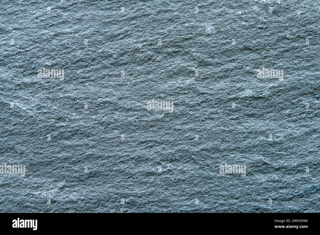 Texture of dark grey slate coaster plate as a background. Stock Photo