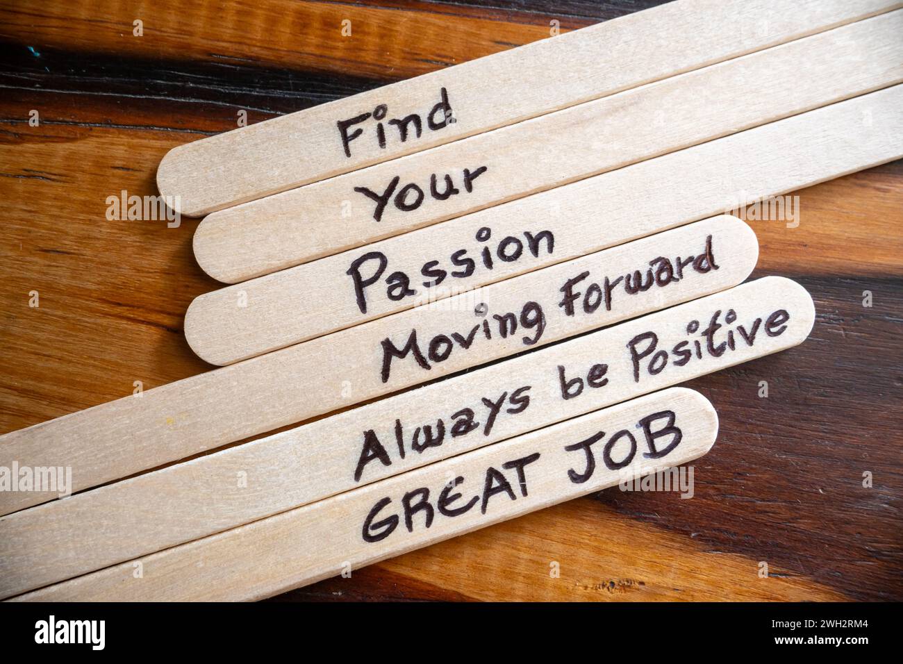 Concept of motivational words on ice cream sticks on a table. Stock Photo
