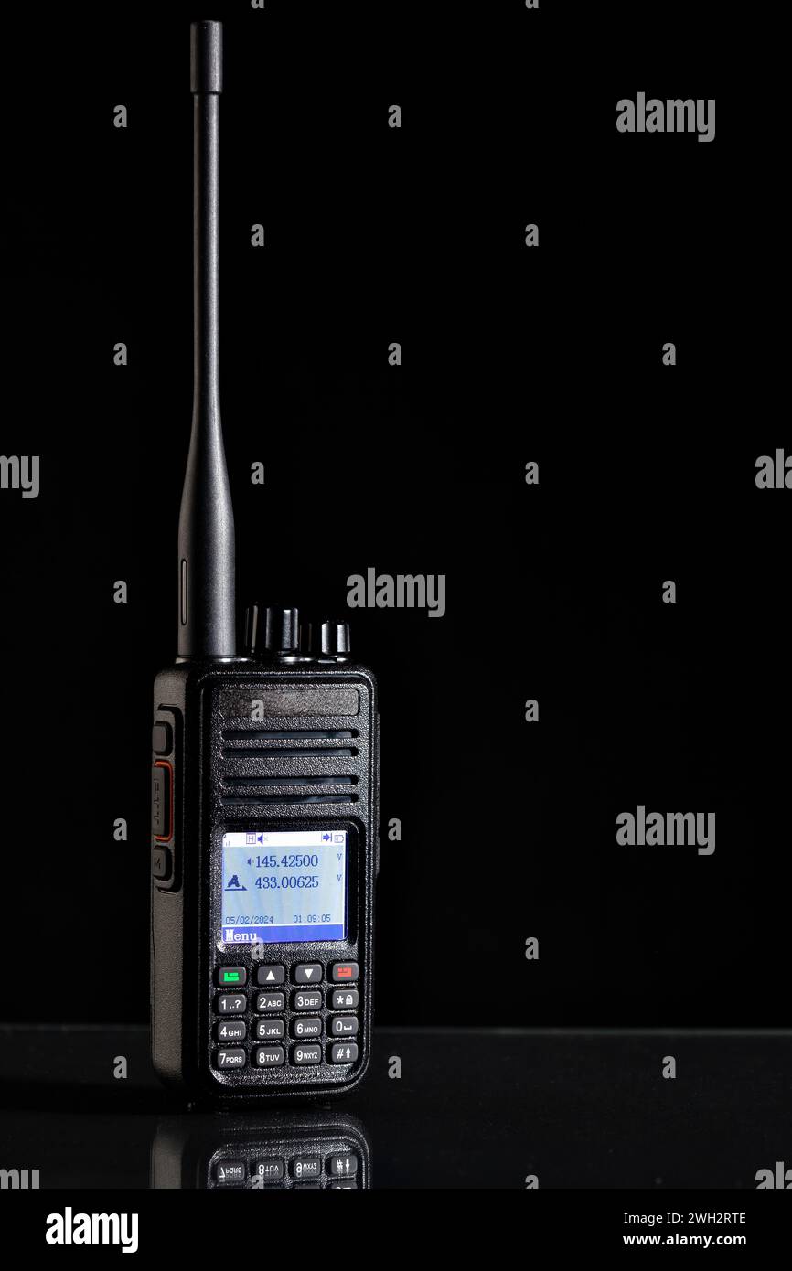 Two-way radio with antenna and color display on the black background Stock Photo