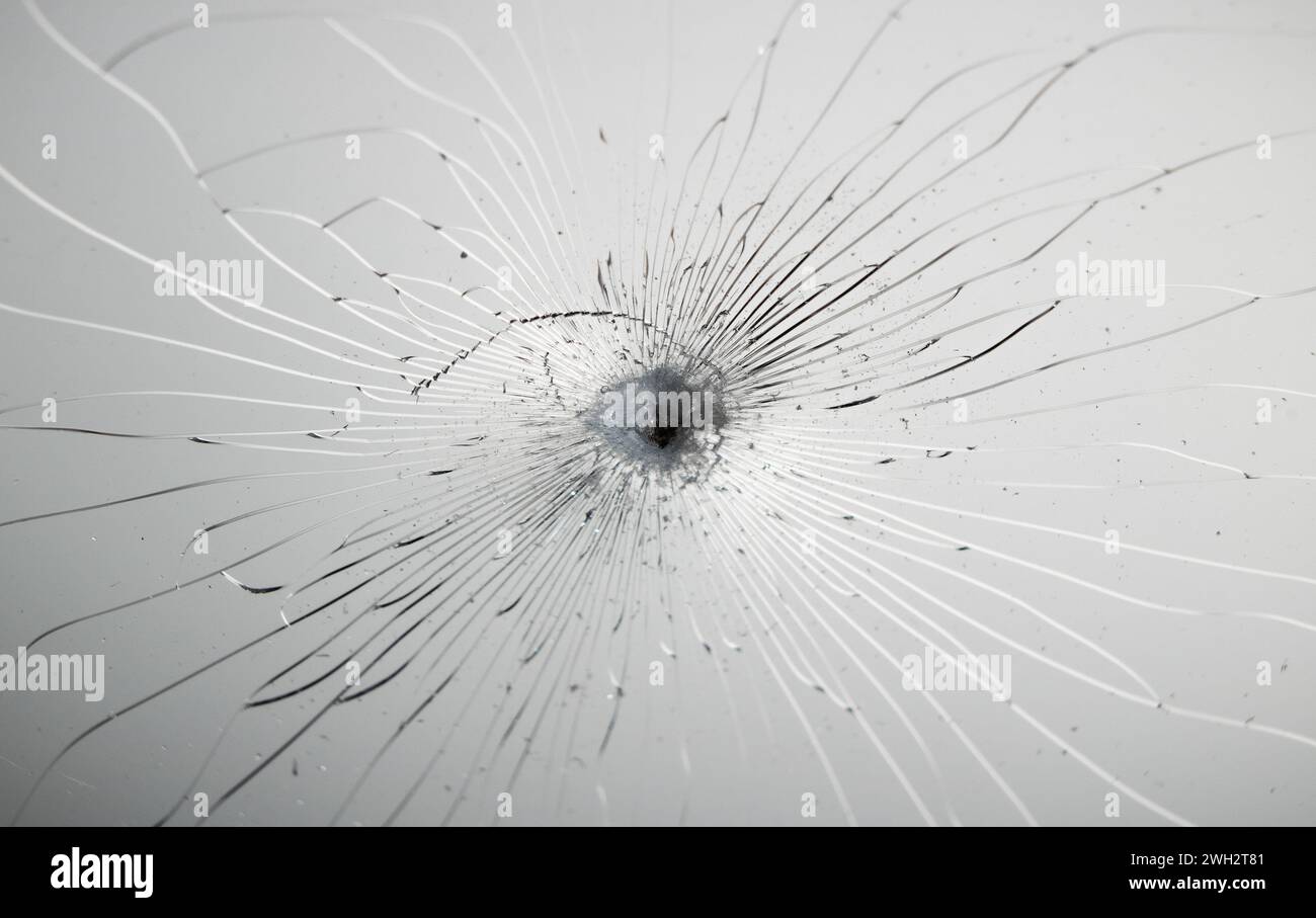 Cracked glass texture on grey background. Stock Photo