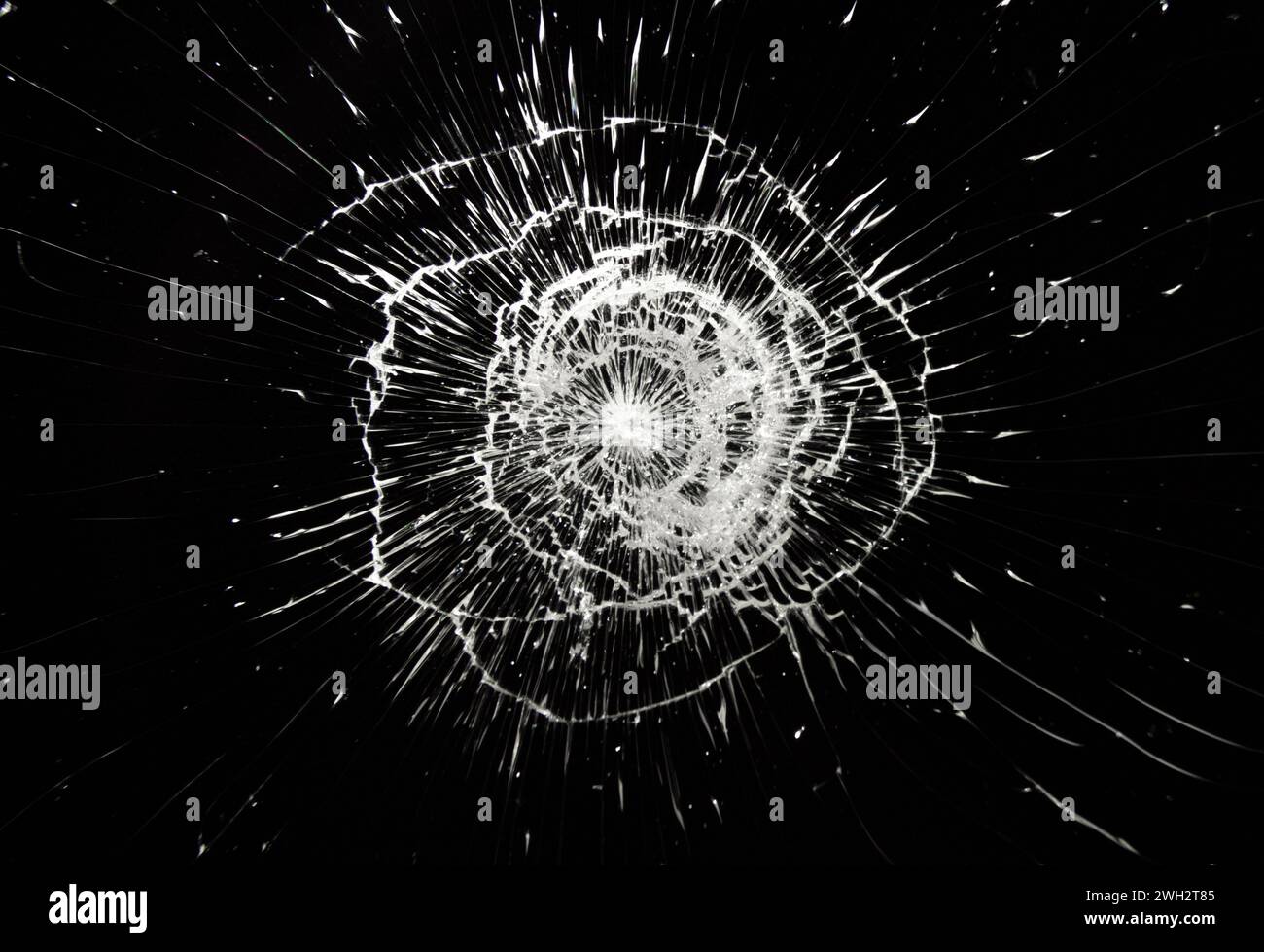 Cracked glass texture on black background. Stock Photo