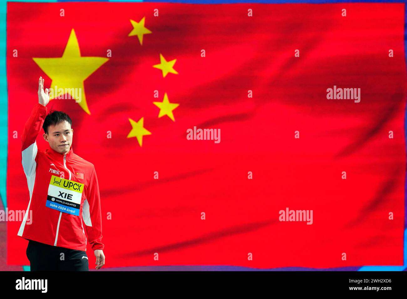 Xie Siyi of China waves as he arrives for the men's 3m springboard ...