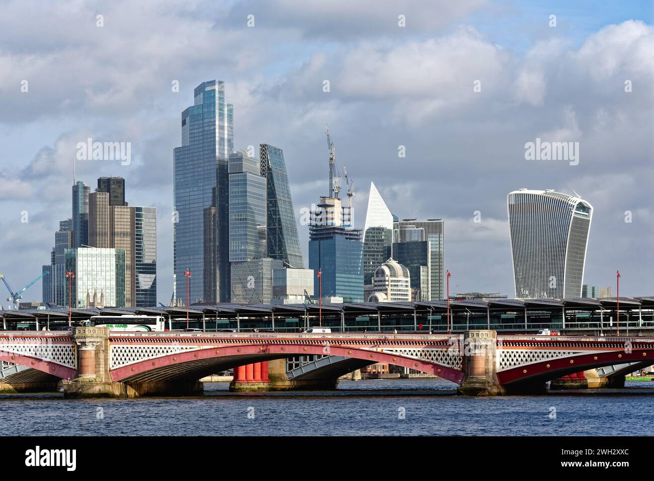 The ever changing modern skyline of the City of London viewed from across from the south bank of the River Thames on a sunny winters day England UK Stock Photo