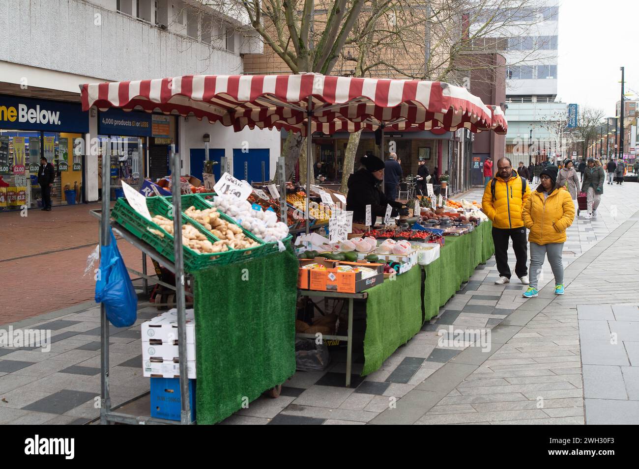 Slough, Berkshire, UK. 7th February, 2024. Shoppers at a fruit and veg stall in Slough High Street, Berkshire. Credit: Maureen McLean/Alamy Stock Photo