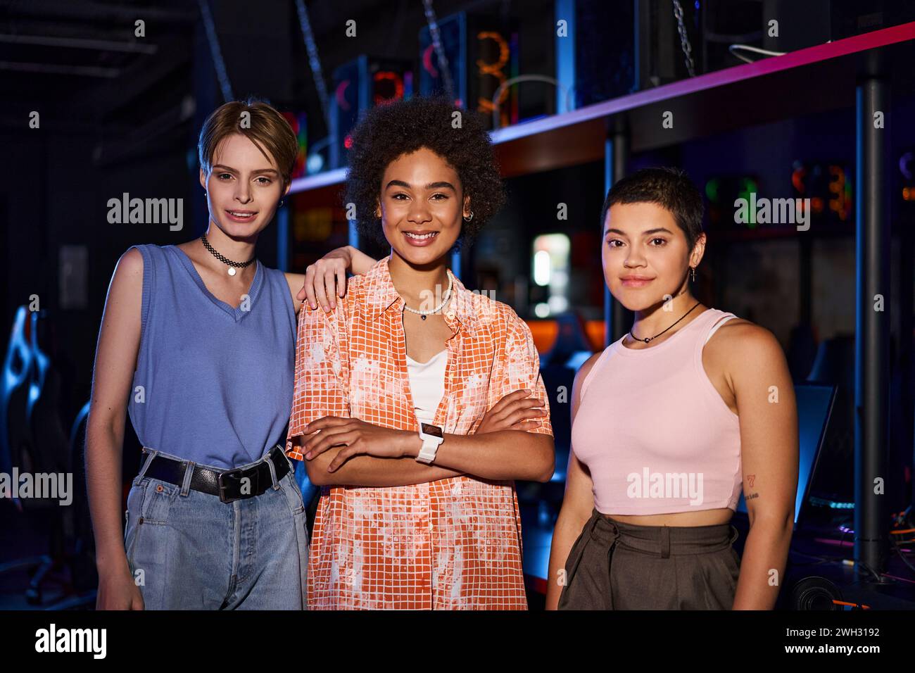 A stylish group of women with radiant smiles and fashionable clothing gather for a fun night out Stock Photo