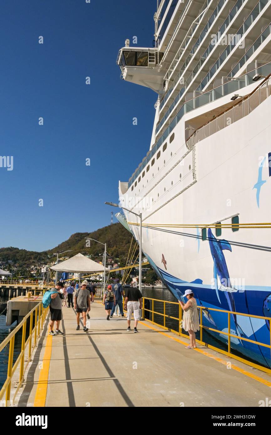 Manzanillo, Mexico - 16 January 2024: Cruise ship passengers returning to the Norwegian Bliss ocean liner, which is operated by NCL Stock Photo