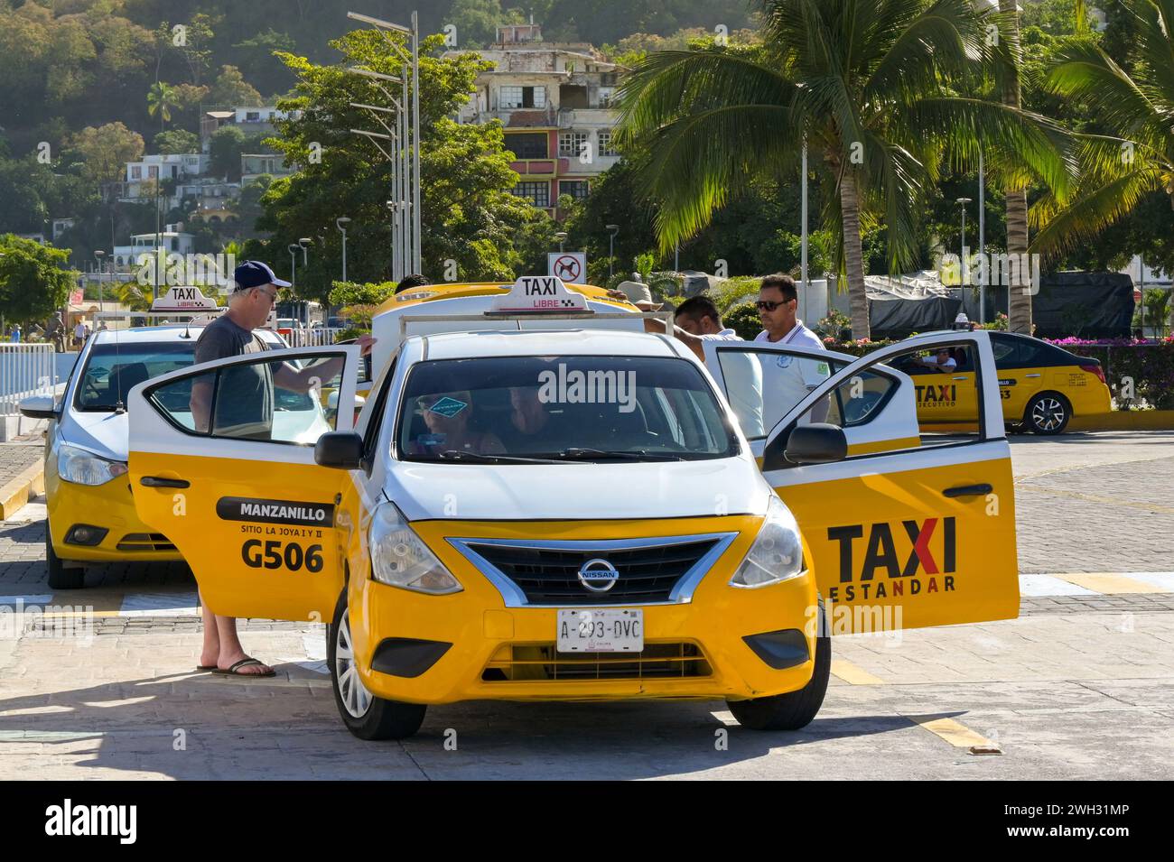 Manzanillo, Mexico 16 January 2024 Tourists getting in a taxi at the