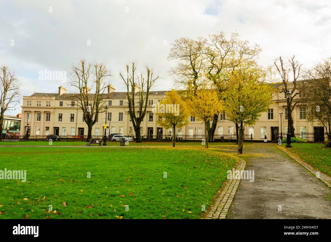 Belfast, County Down, November 18 2023 - Flats and hotel in Regency style buildings in Upper Crescent Belfast Crescent garden in the foreground Stock Photo