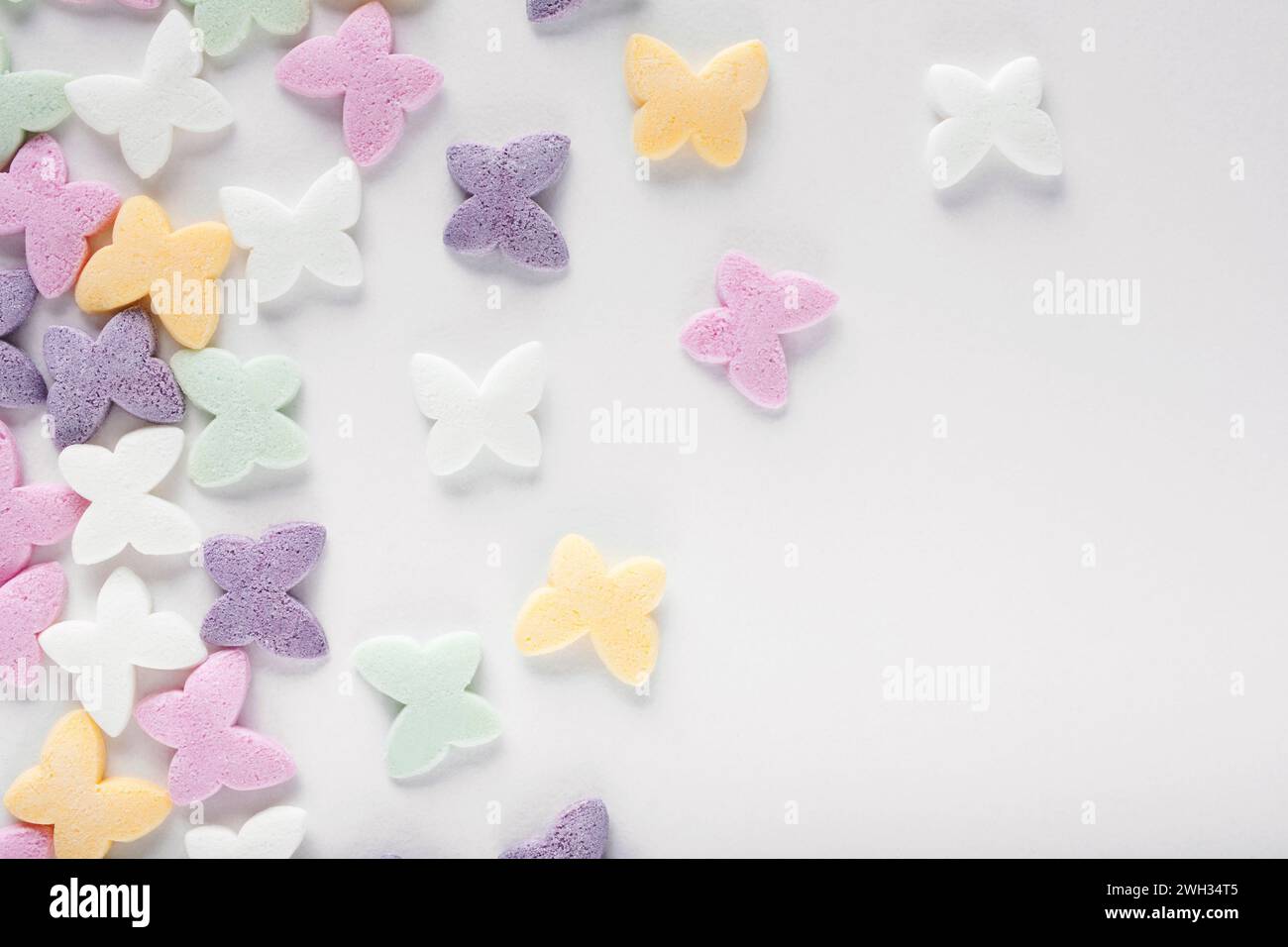 Colorful sugar sprinkles on white background Stock Photo