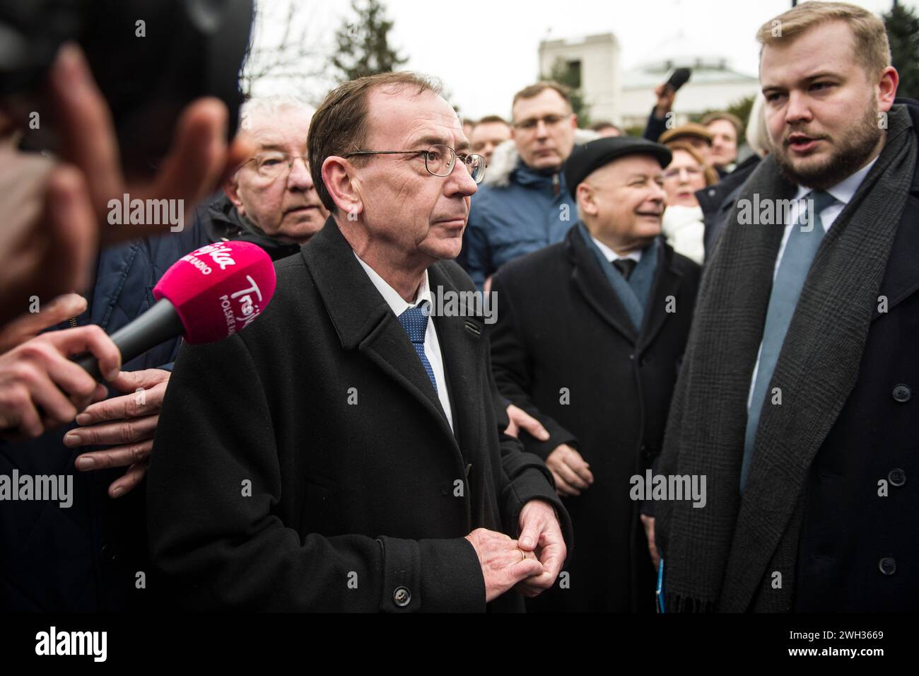 Former Minister of Interior and Administration, Mariusz Kaminski who is released from prison after a second presidential pardon attempts to enter the Parliament surrounded by MPs of the Law and Justice Party. Former interior minister, Mariusz Kaminski and his deputy Maciej Wasik were jailed last month after being sentenced for abuse of power for actions taken in 2007, when they served in an earlier Law and Justice-led government and previously led the Central Anti-Corruption Bureau (CBA). They claimed to be 'political prisoners' and they also lost their parliamentary mandates.They tried to pus Stock Photo