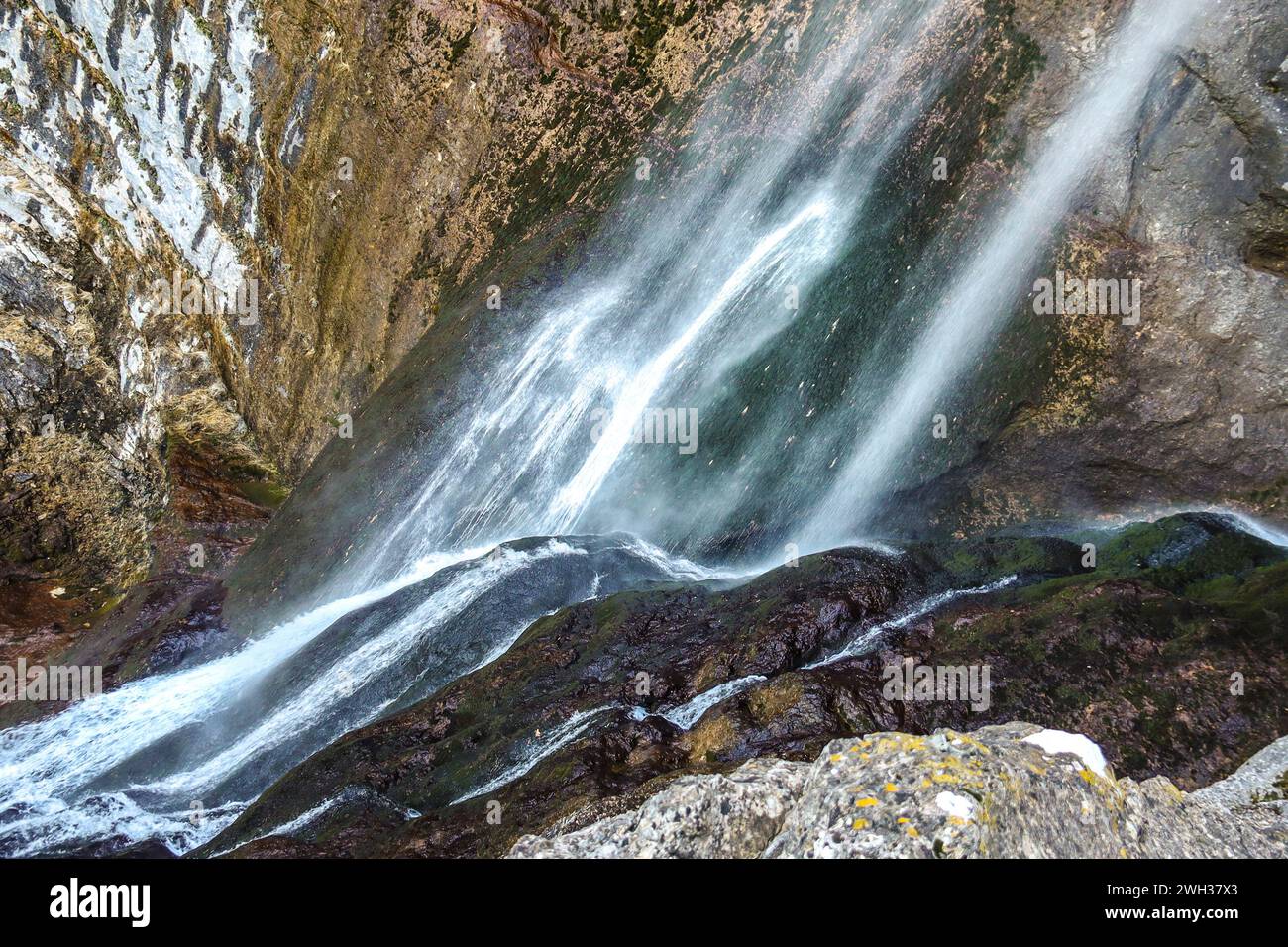 Waterfall with colorful rock wall in Nacimiento del Rio Mundo in Sierra de Alcaraz, Albacete province, Spain Stock Photo