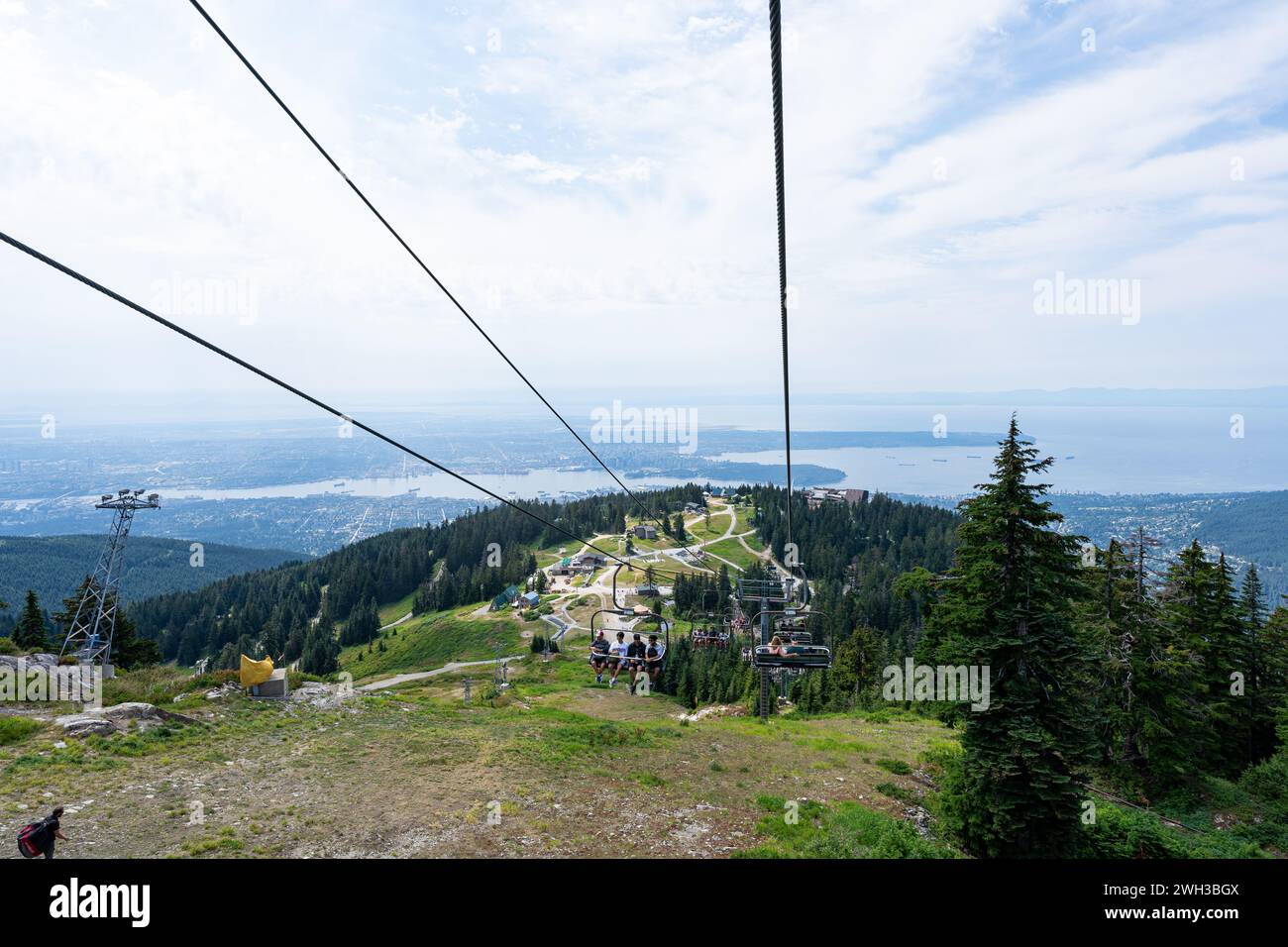 The view from the Grouse Mountain chairlift with Vancouver in the distant background. Stock Photo