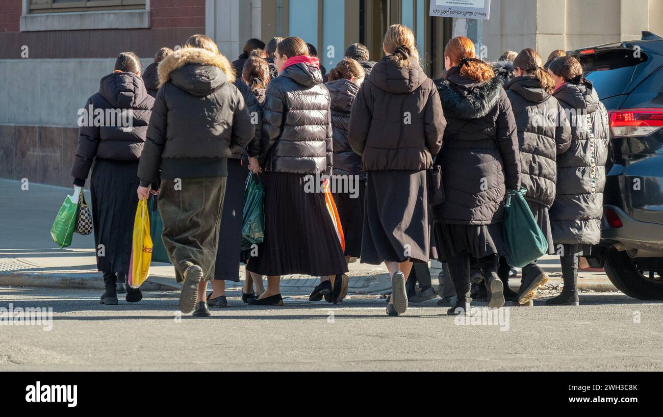 A very large group of orthodox Jewish girls in long skirts, go to school on a winter Sunday morning Stock Photo