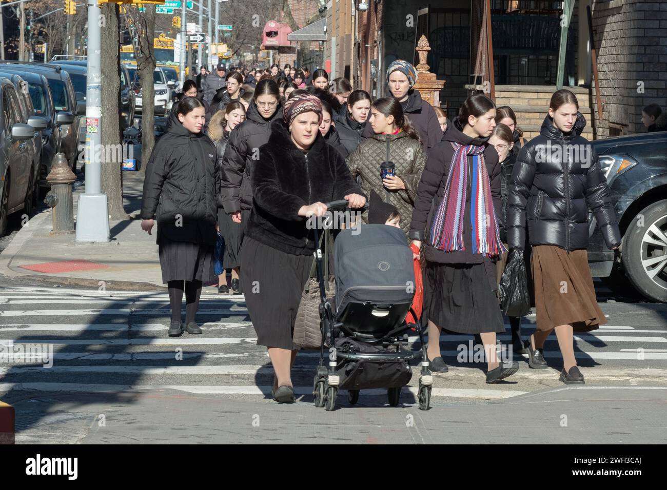 Orthodox Jewish women, primarily students going to school, cross a street on Harrison Avenue in Williamsburg, Brooklyn, New York. Stock Photo