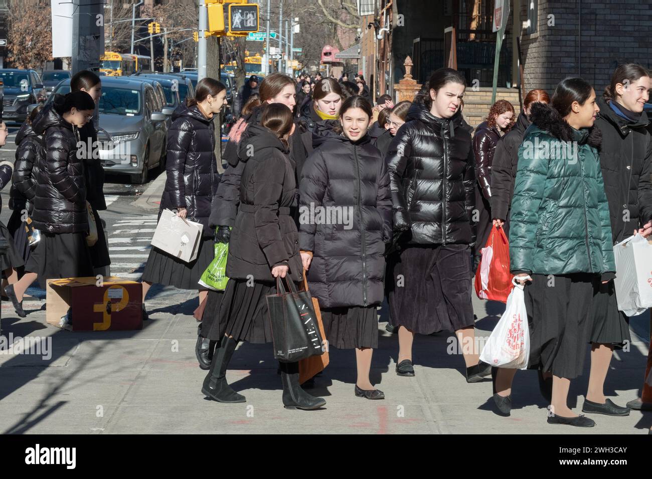 A very large group of modestly dressed orthodox Jewish girls go to school on a winter Sunday morning Stock Photo