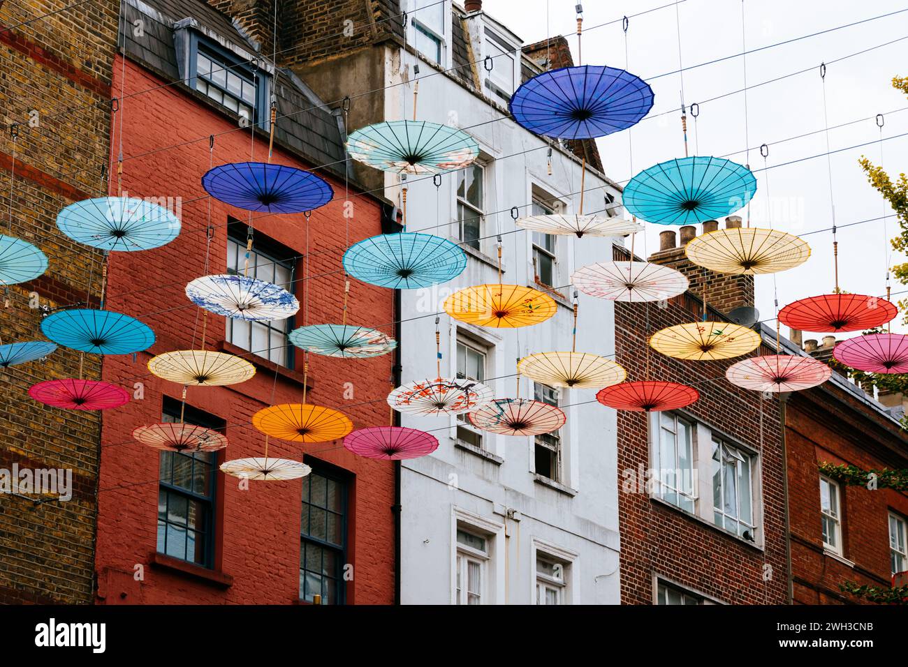 Colorful umbrellas hanging over street in Chinatown in Soho, London Stock Photo