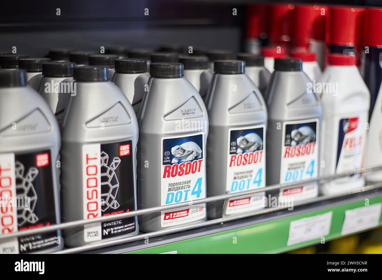 Brake fluid Rosdot in gray bottles on shelf at gas station store. Automotive products for car maintenance. Bishkek, Kyrgyzstan - 26 May 2023. Stock Photo