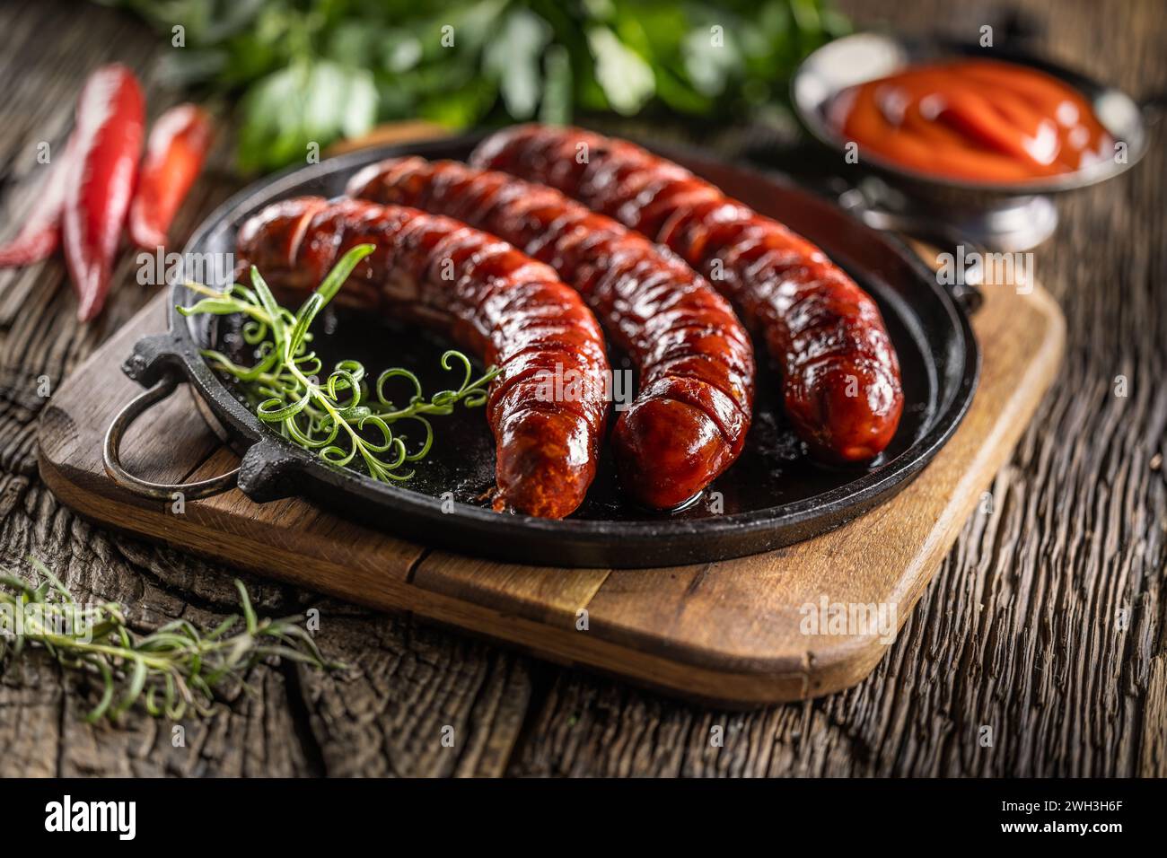 Sausages fried with spices bbq sauce and herbs - Close up. Stock Photo