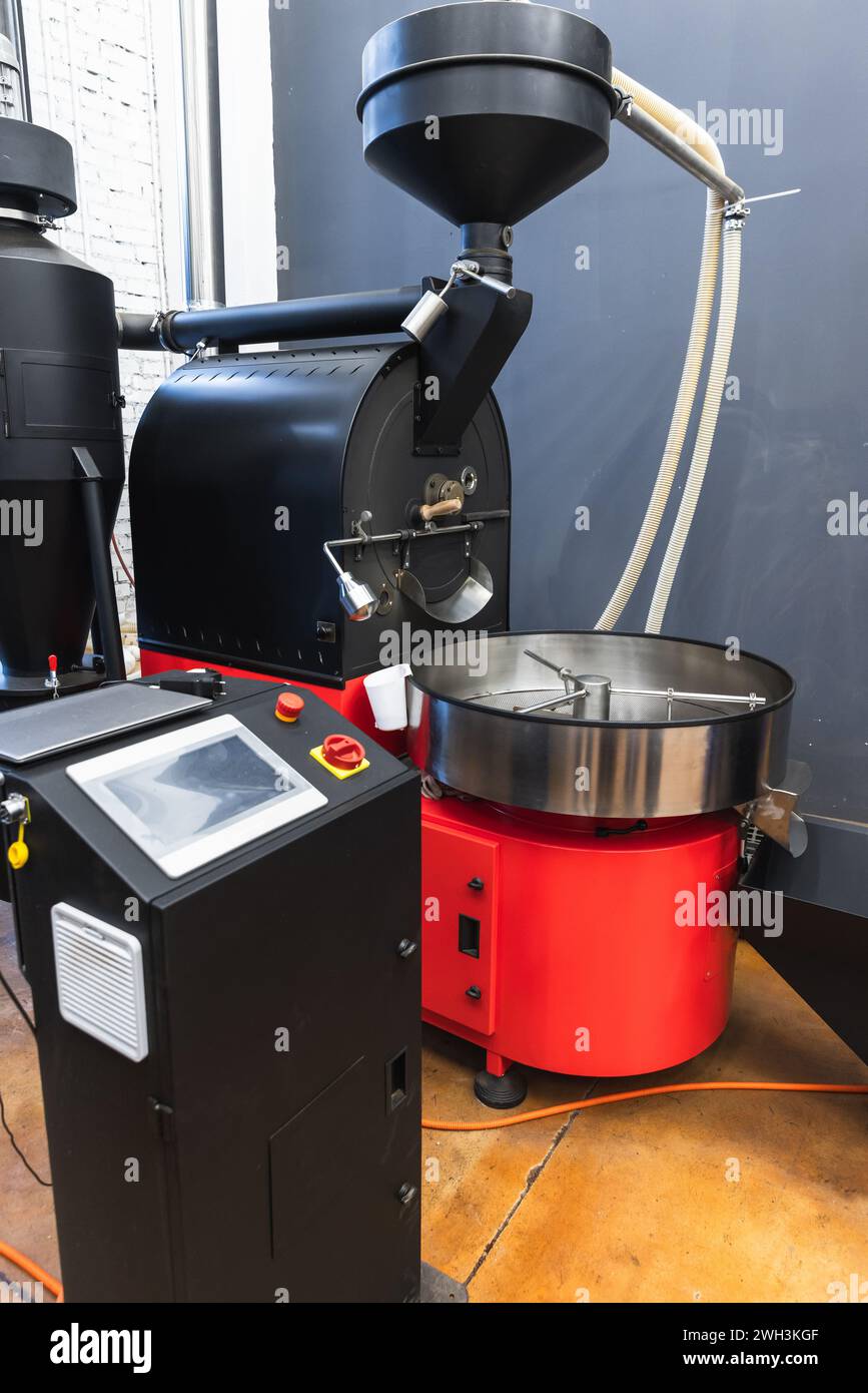 Coffee roaster with electronic control panel in a coffeehouse, vertical photo of industrial roastery equipment Stock Photo