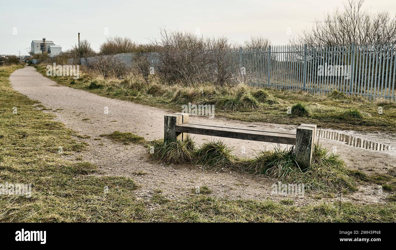 Wooden seat in Wyre country park adjacent the former ICI site in Thornton,Lancashire,uk Stock Photo