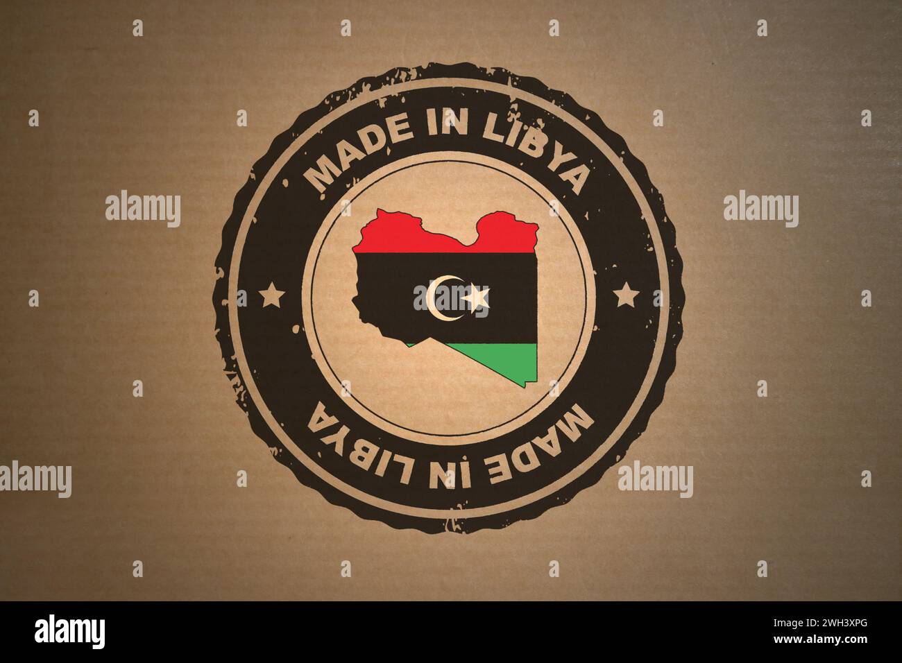 Brown paper with in its middle a retro style stamp Made in Libya include the map and flag of Libya. Stock Photo