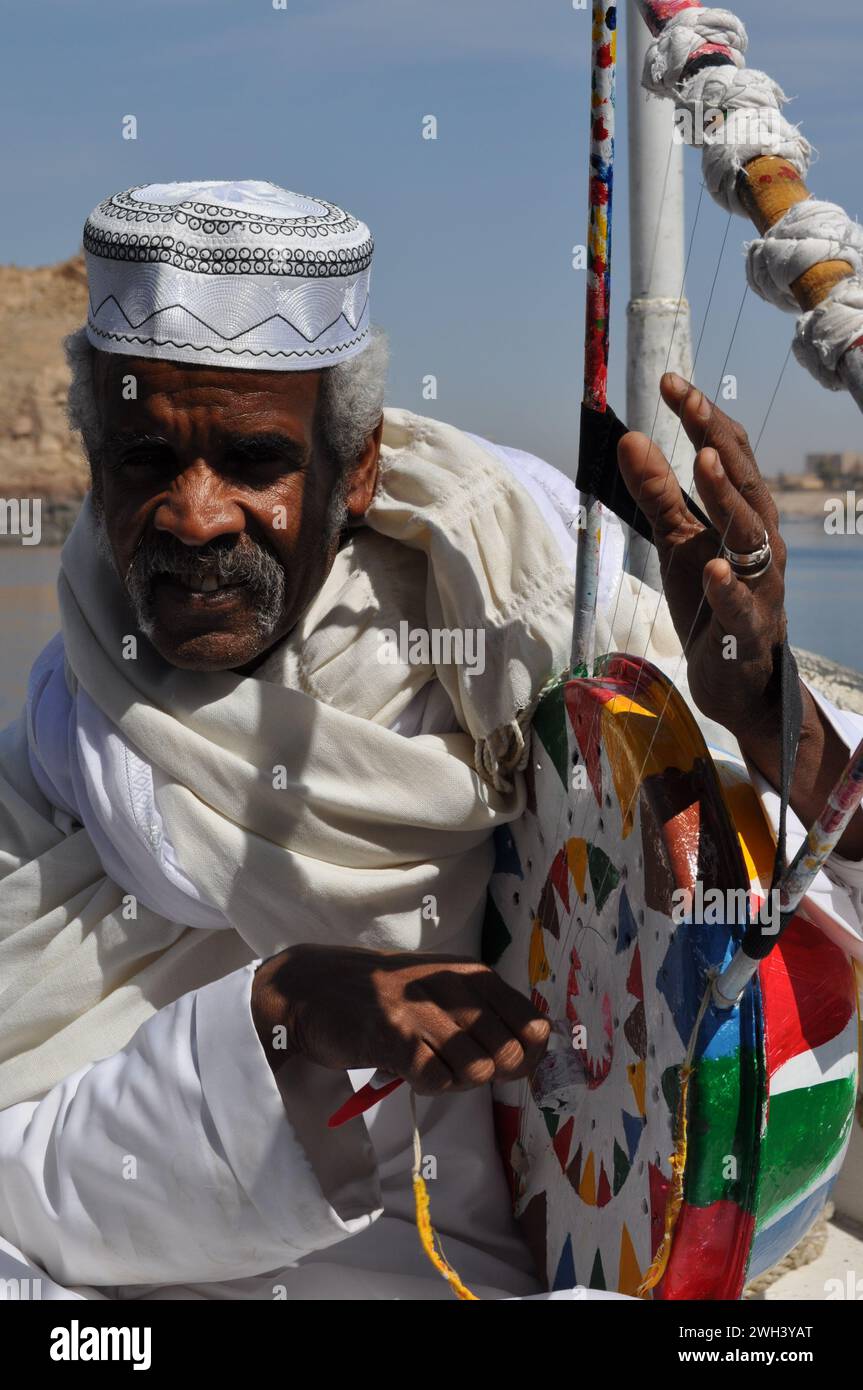 Oriental Nubian Musician On a boat behind aswan dam Stock Photo