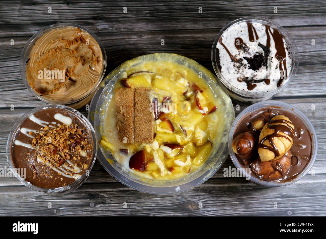 Background of assorted desserts of chocolate profiteroles, creamy ...