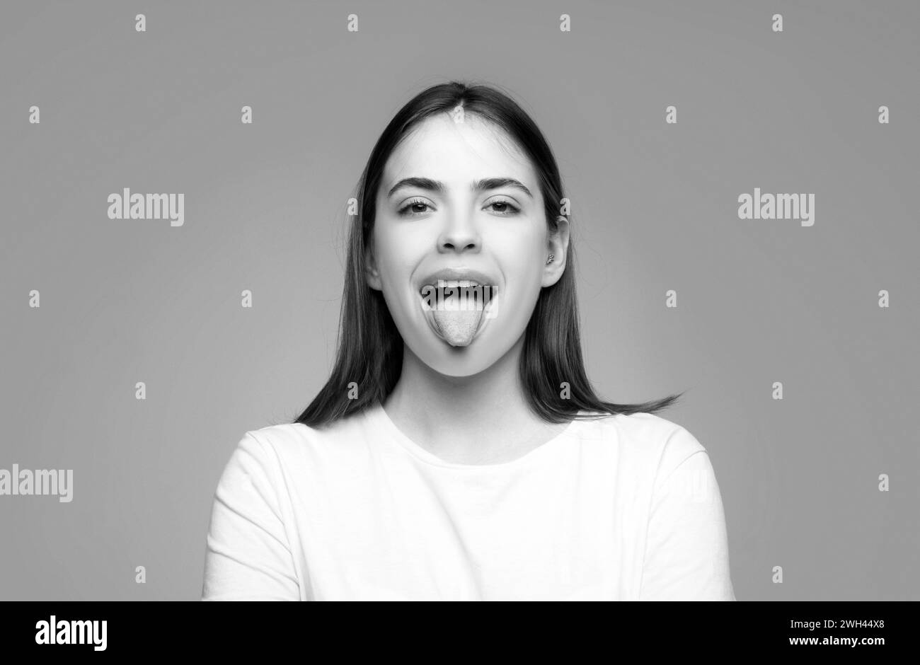 Beautiful modern model shows tongue. Model with sticking tongue out